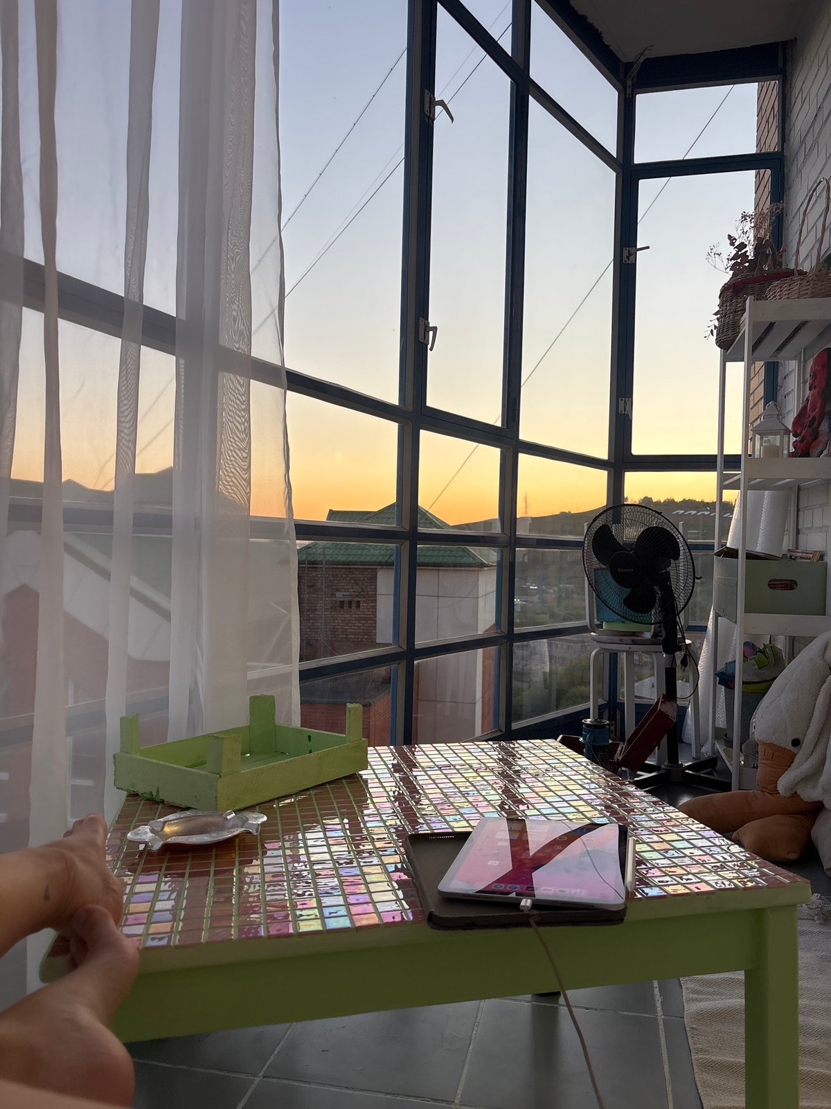 Friends toast with pink drinks in Krasnoyarsk sunroom