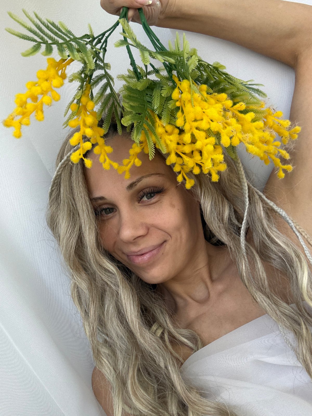 Woman photographed with mimosa flowers in Rusanovo studio session