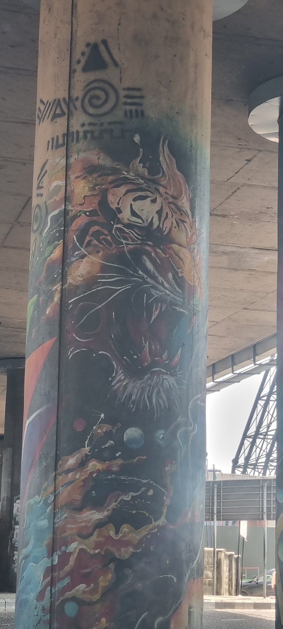 Vibrant graffiti art spotted on concrete infrastructure beam