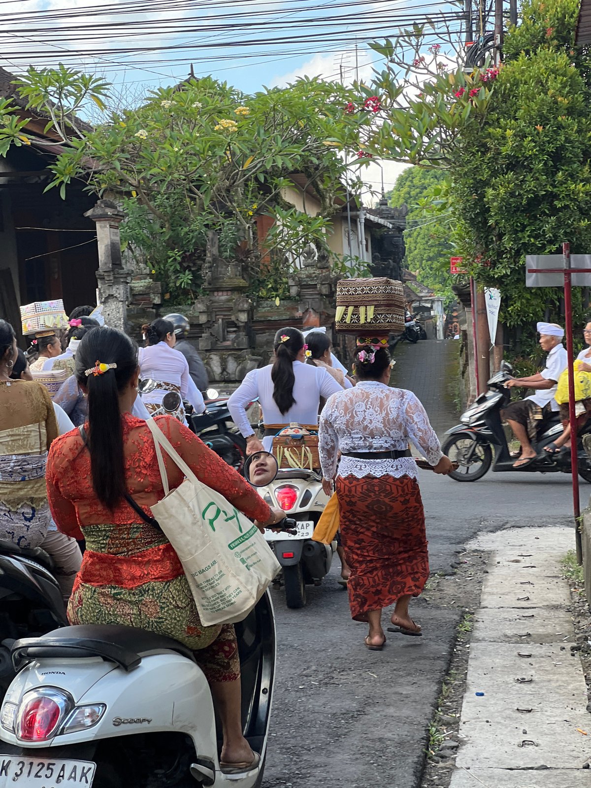Balinese Hindus carry offerings to temple ceremony in Singakerta