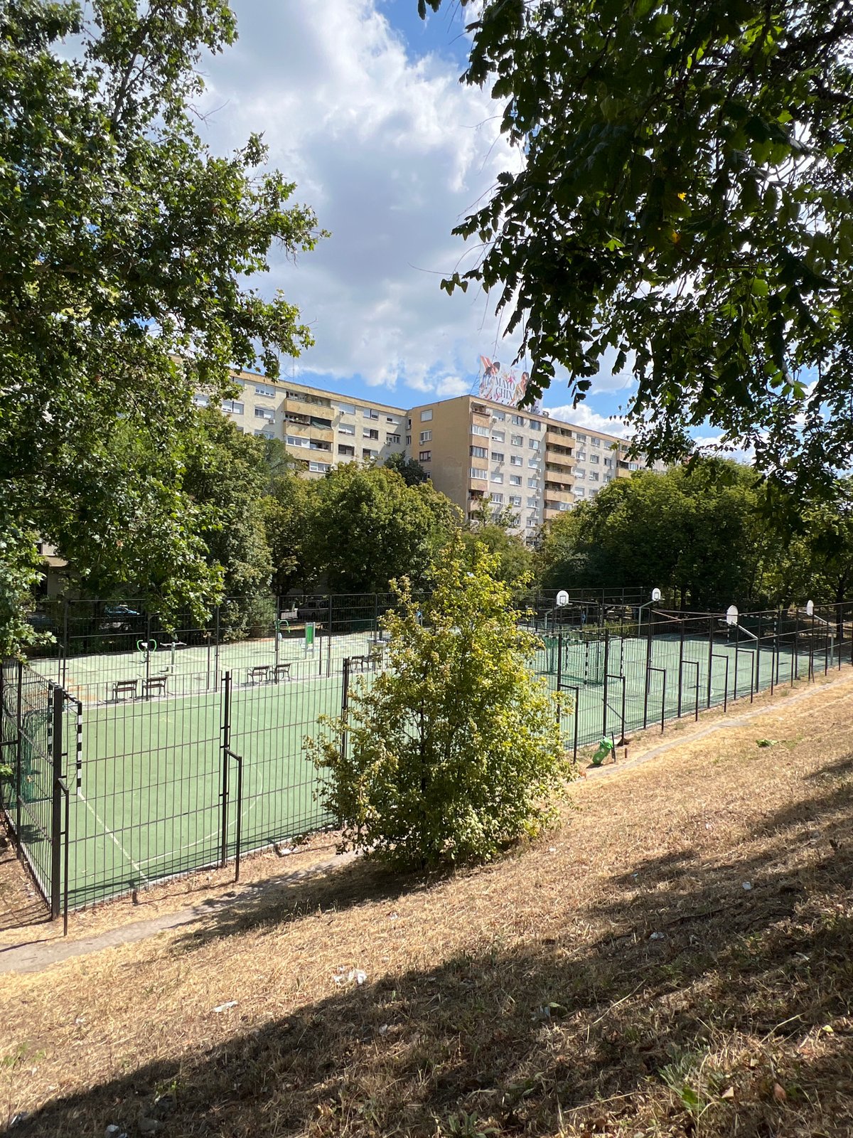 Budapest street-level mix: sports court meets modern office block