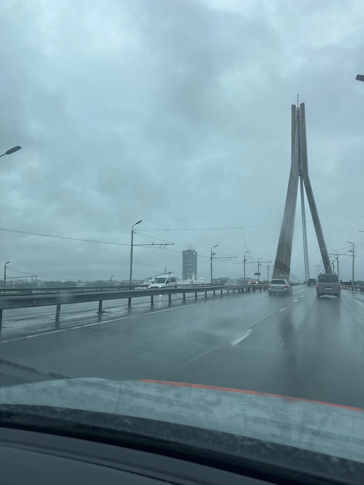 Crossing a rain-soaked cable-stayed bridge in Riga