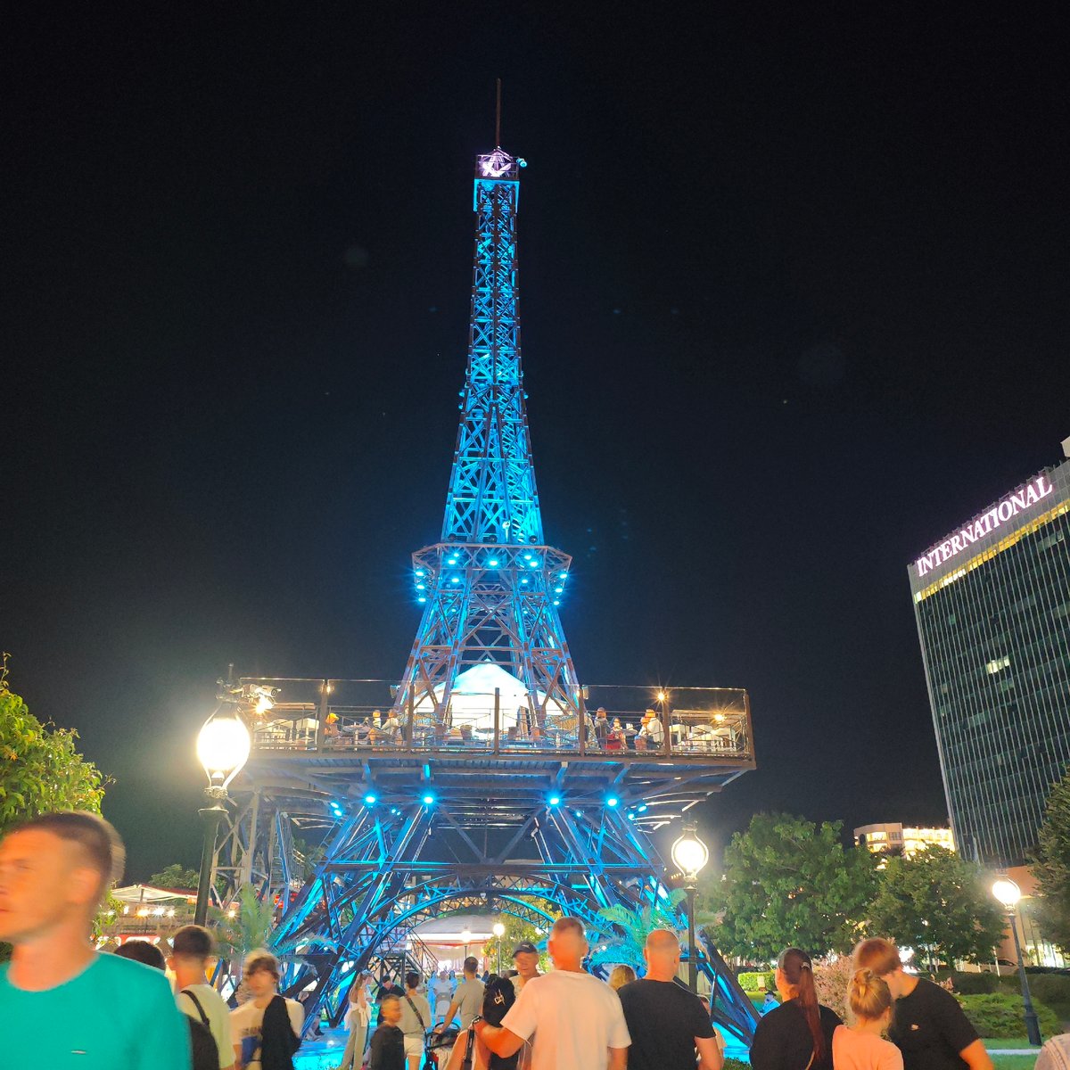 Evening nightlife captured at Varna entertainment district with tower replica