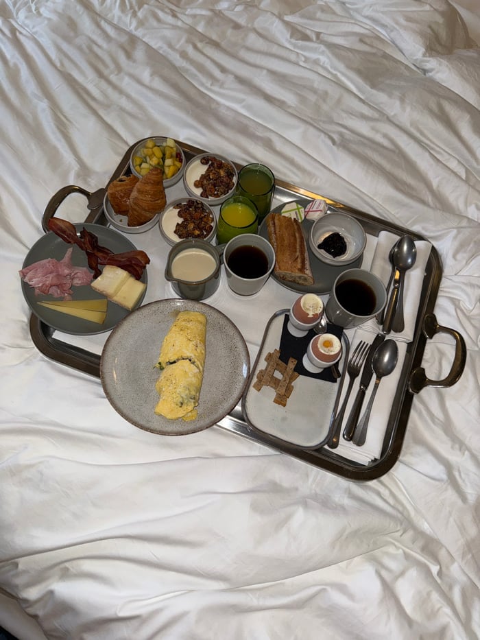 Breakfast tray documented on bed in Paris morning