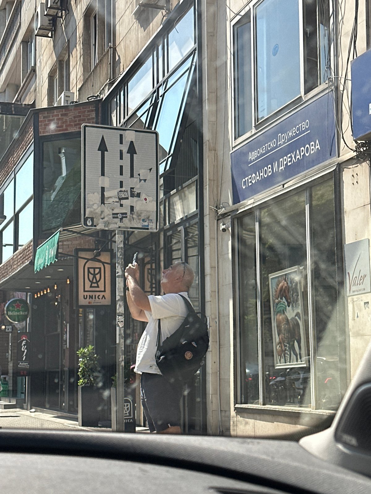 Phone and mug on a Sofia sidewalk, July morning