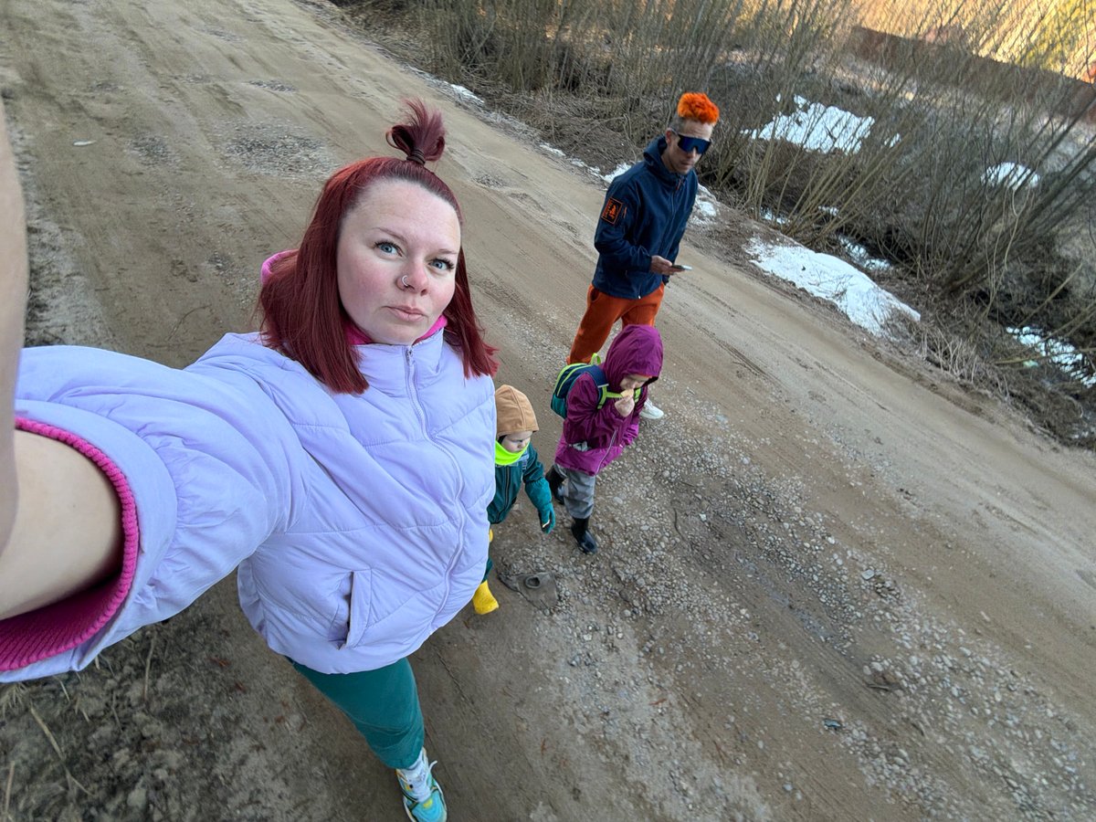 Family walks dirt roads in early morning Chaikovsky Russia