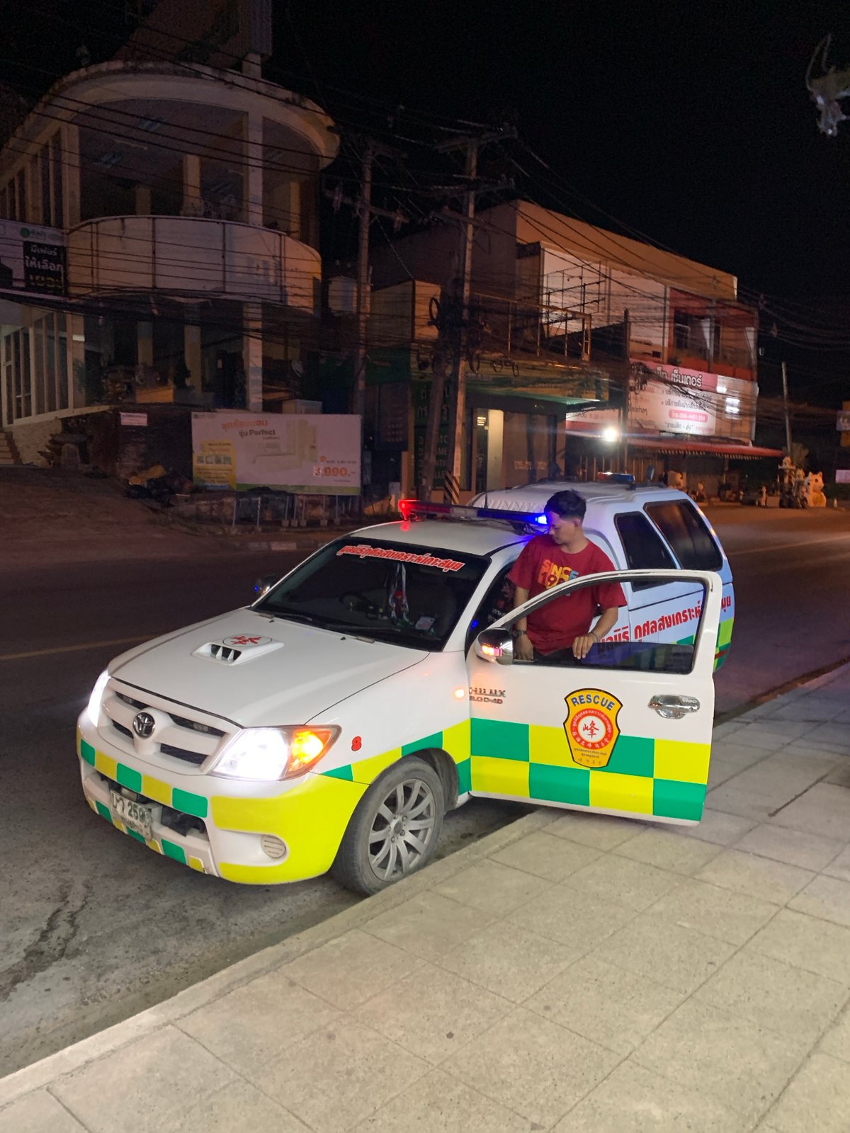 Ambulance parked roadside at night in Baan Bo Phut