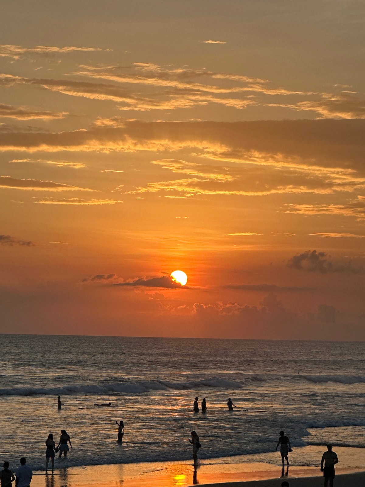 Sunset beach scenes with surfboards captured by witness