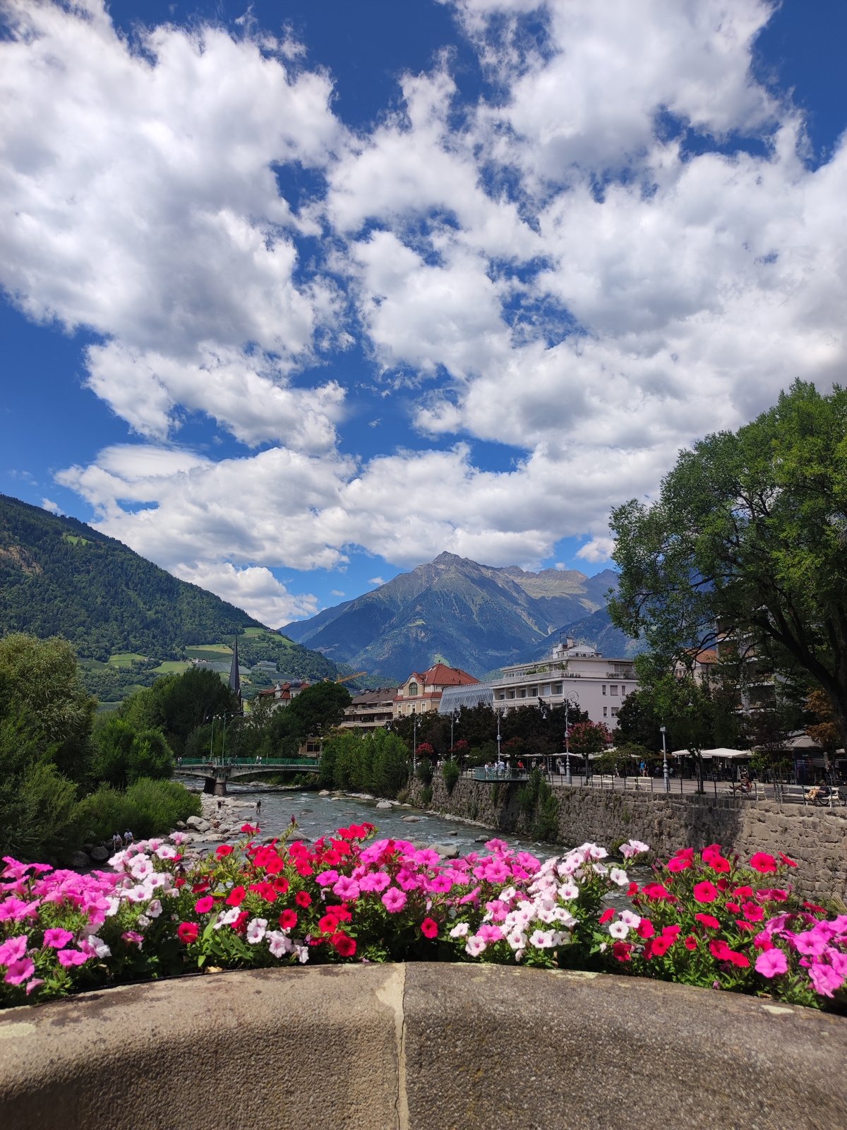 Flowers line the Passer River in Merano, Italy