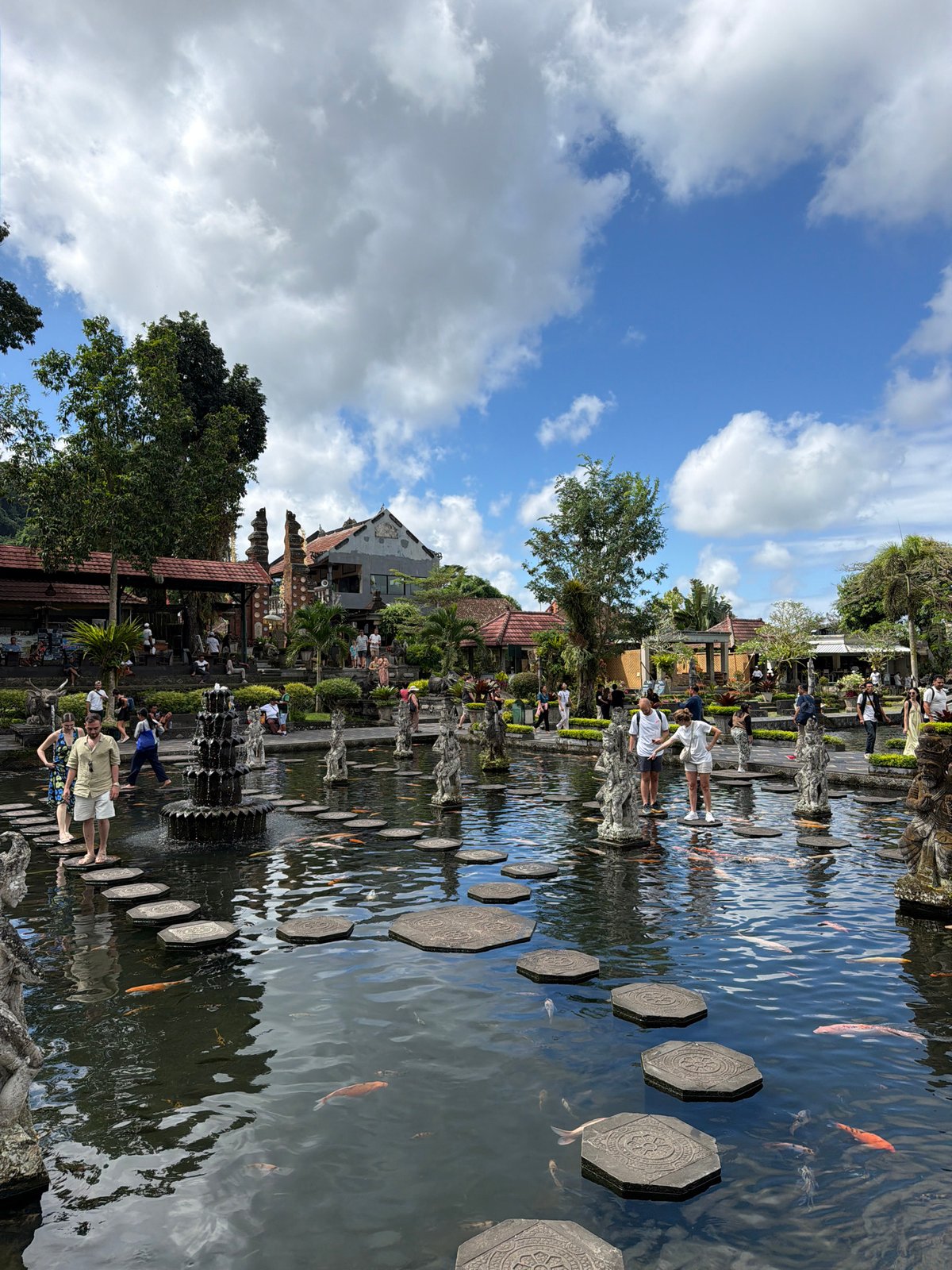 Koi ponds and stone statues at Tirta Gangga Water Palace