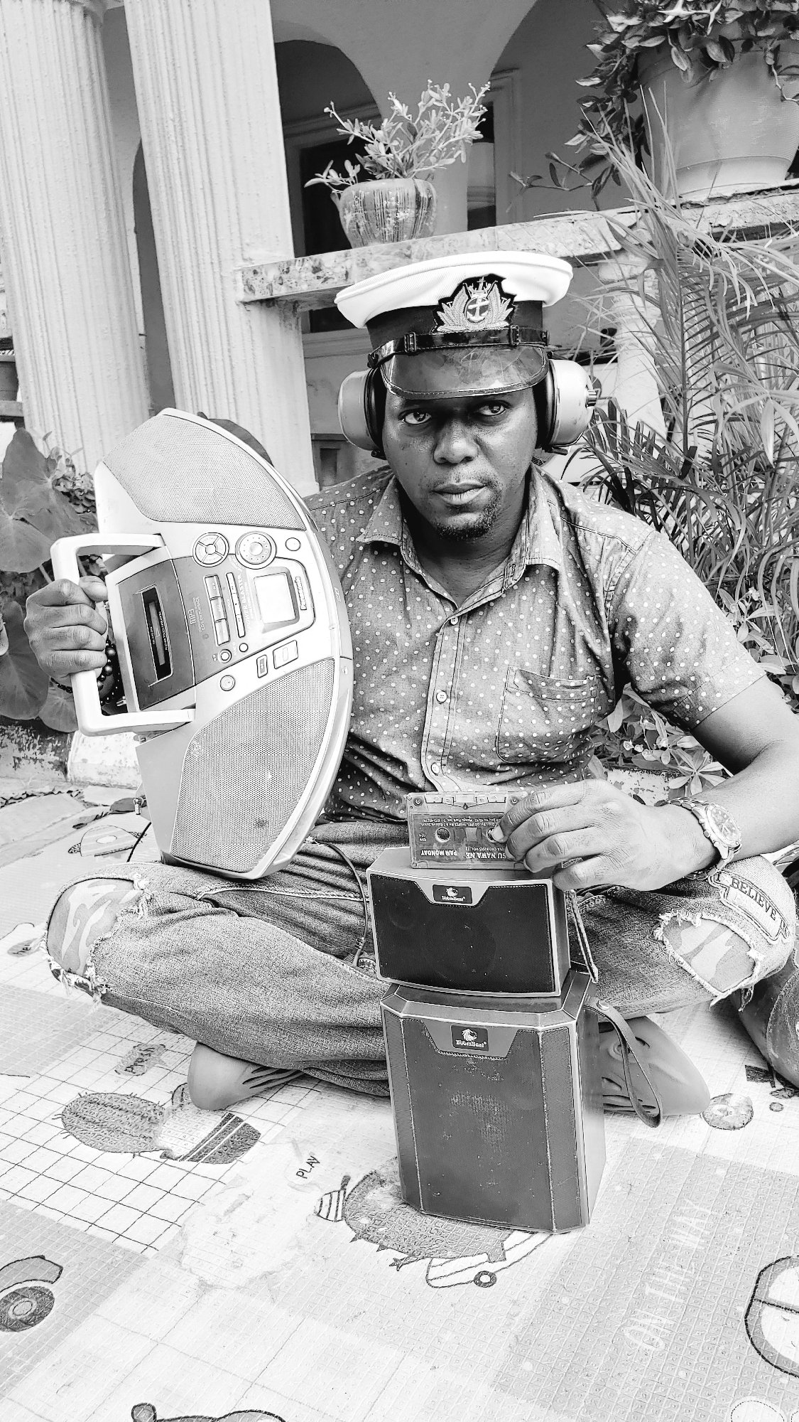 Man operates vintage audio equipment outdoors in Narayi, Nigeria