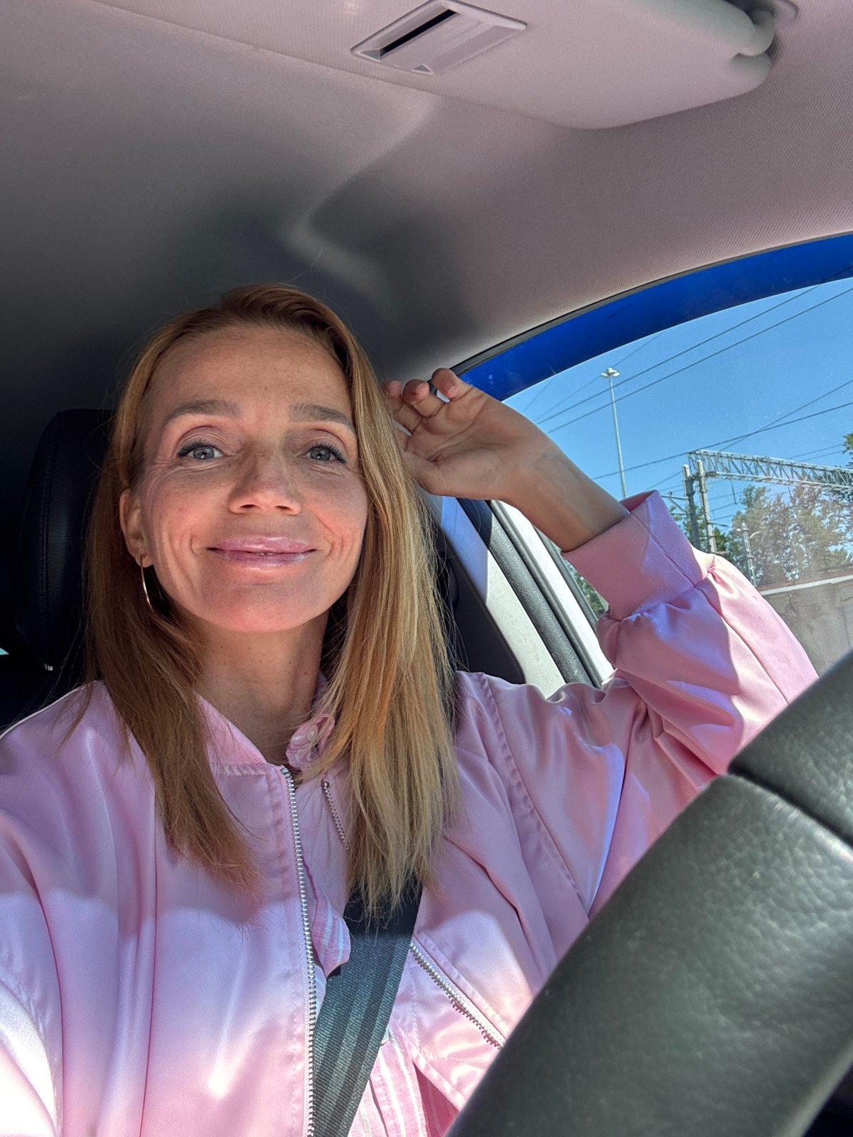 Woman enjoys sunny morning drive through Saint Petersburg