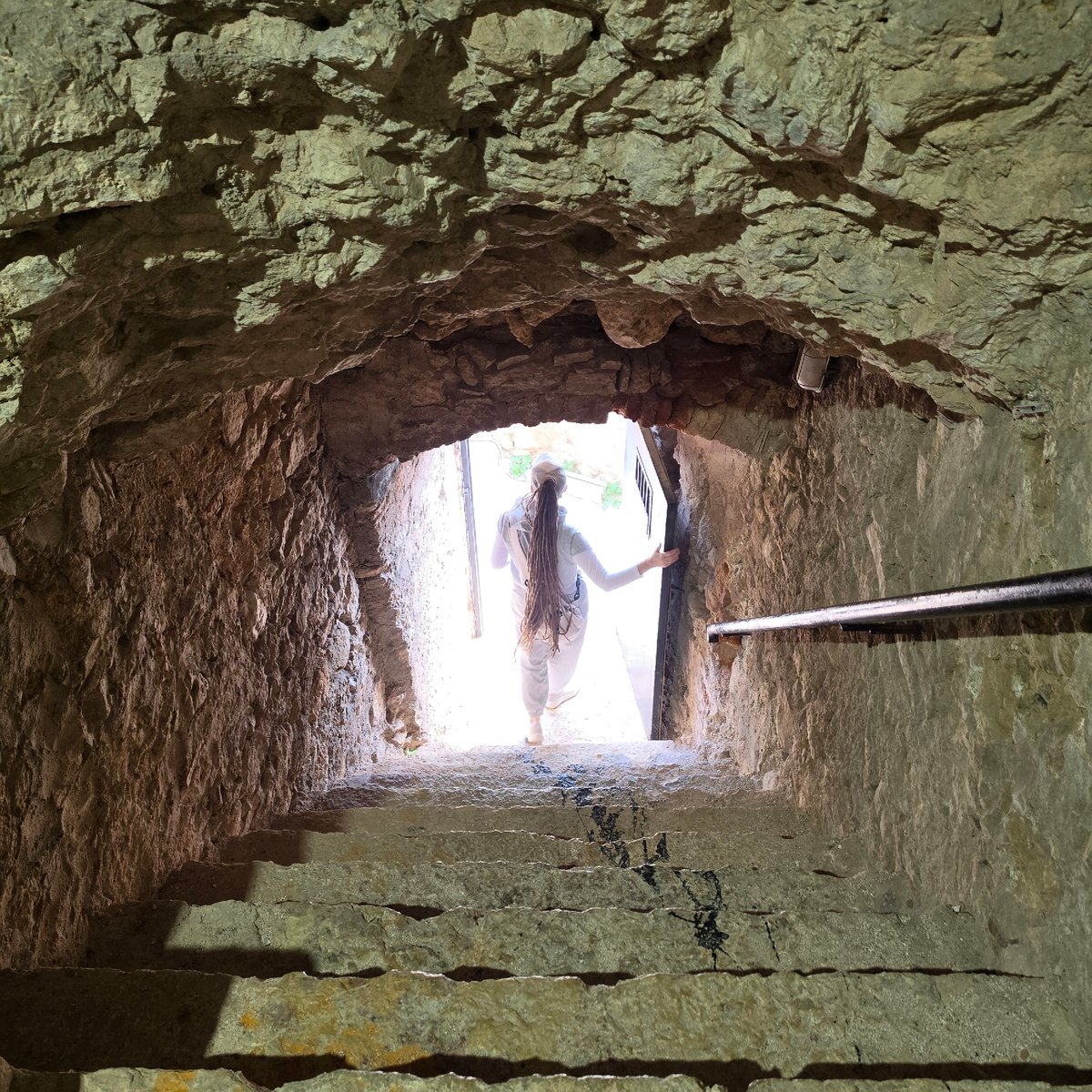 Stone tunnel complex with arched chambers documented by witness