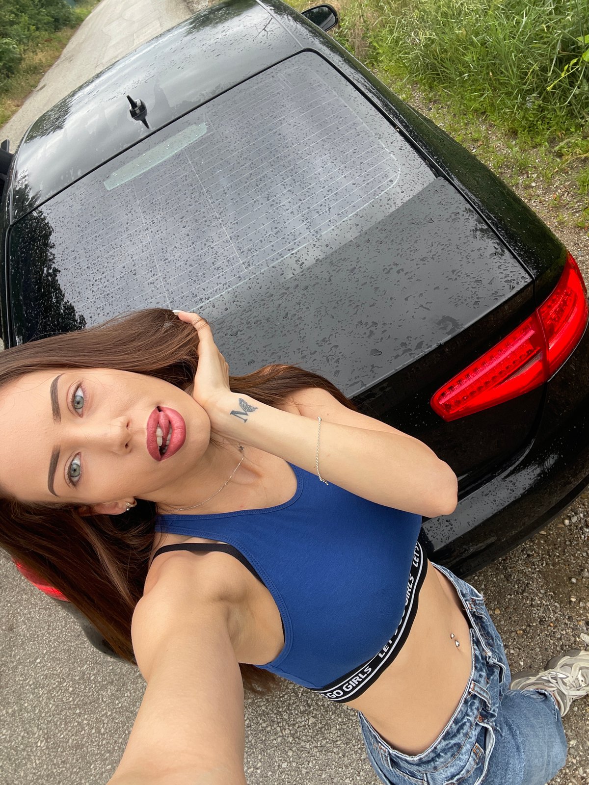 Woman poses with black Audi in impromptu roadside photo session