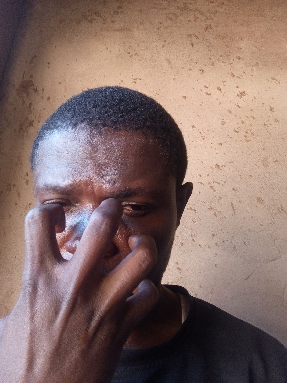Idle indoor moment on a tiled floor in Gombe, Nigeria