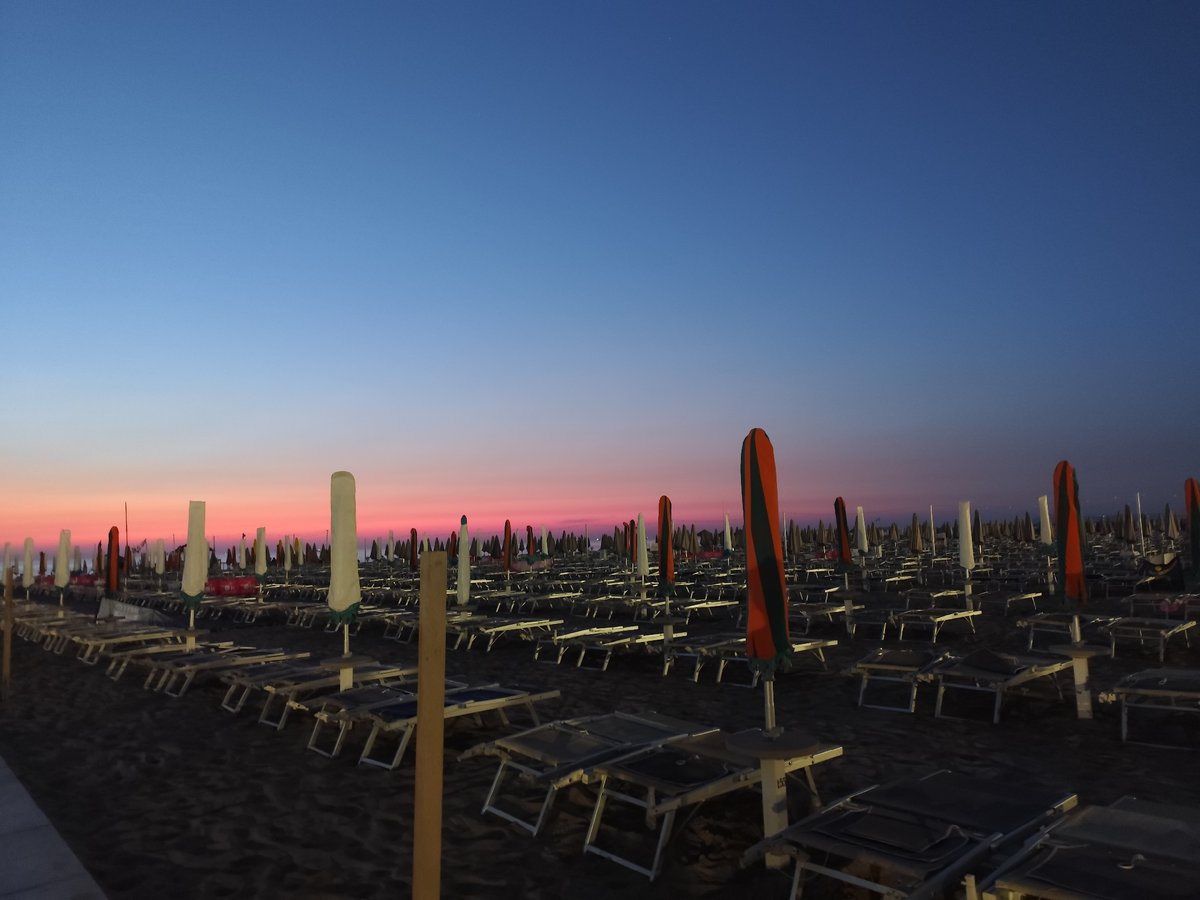 Rimini beach at dawn, quiet shores and pastel skies