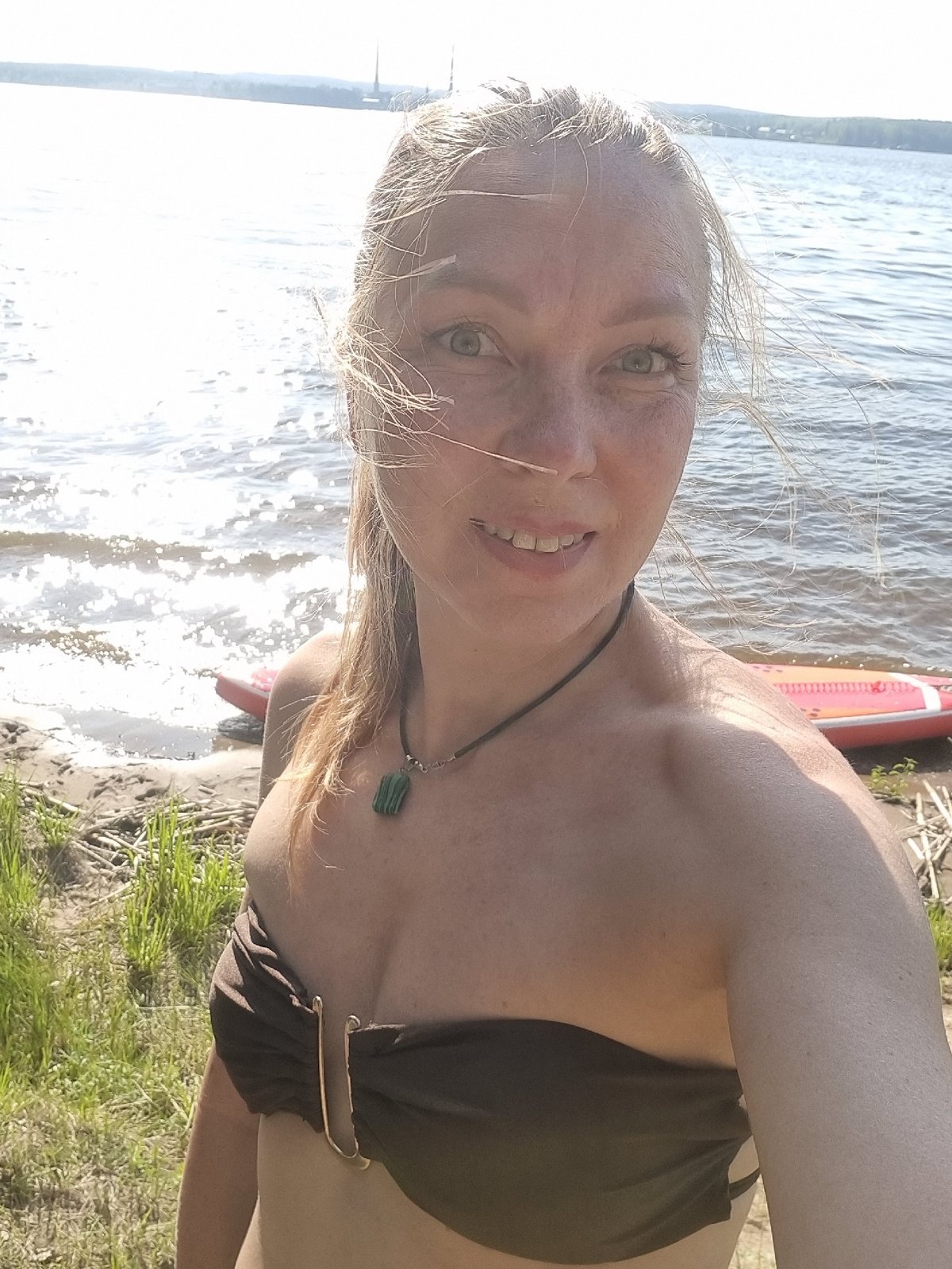 Woman enjoys paddleboarding and kayaking in Chaykovsky forest waterway