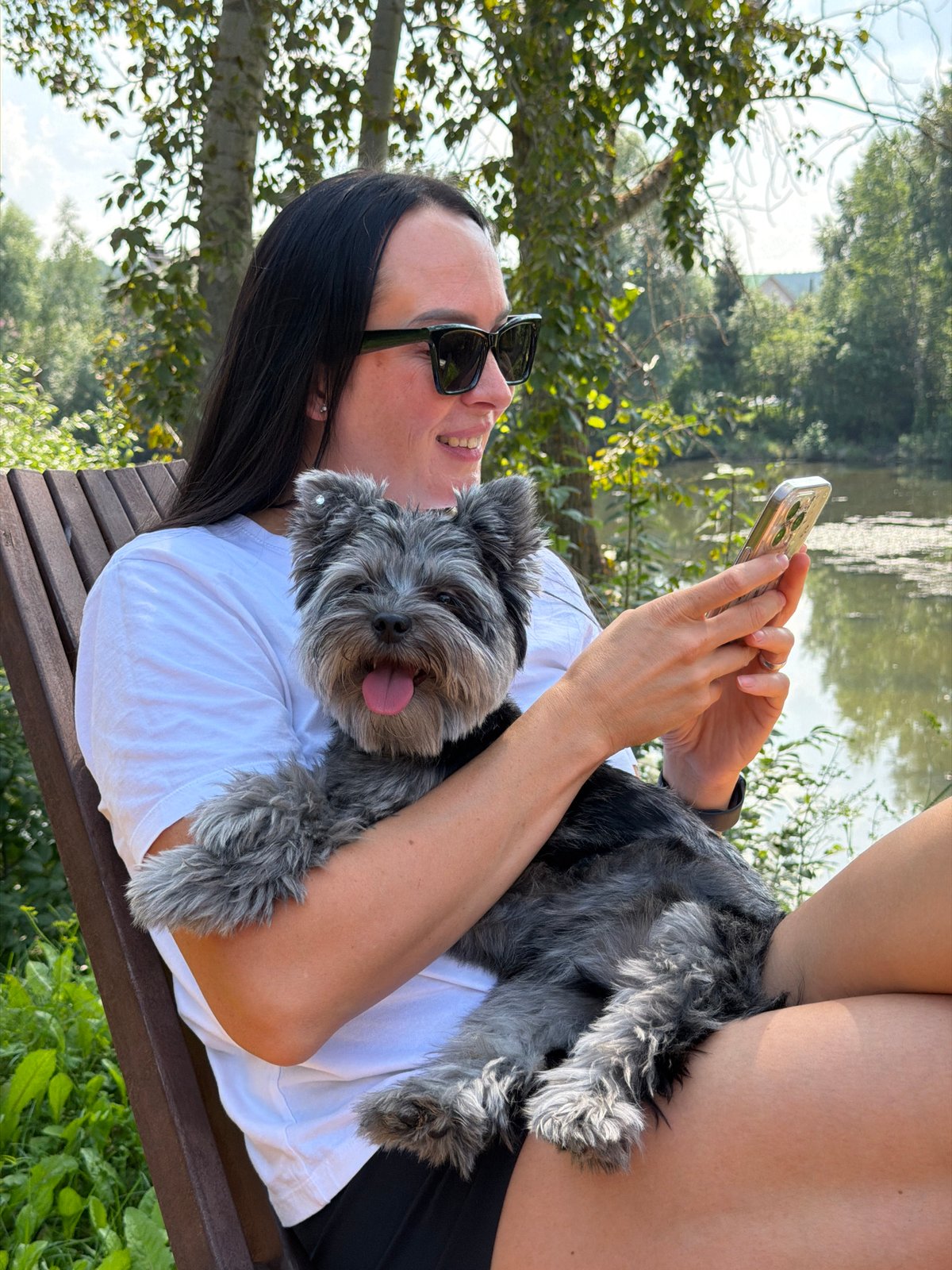 Relaxing on a waterside deck with a scruffy grey dog