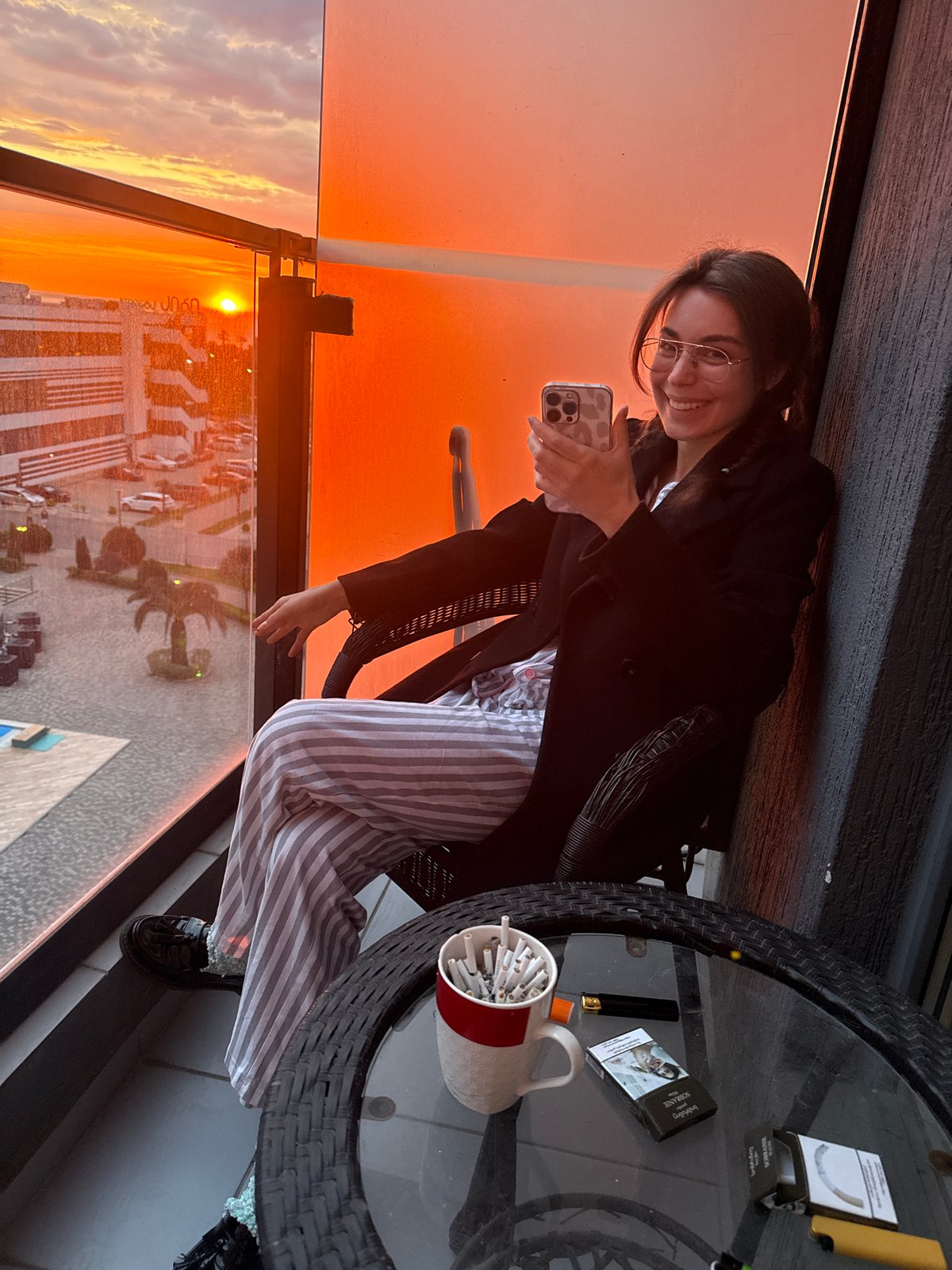 Two women photograph sunset from Batumi balcony