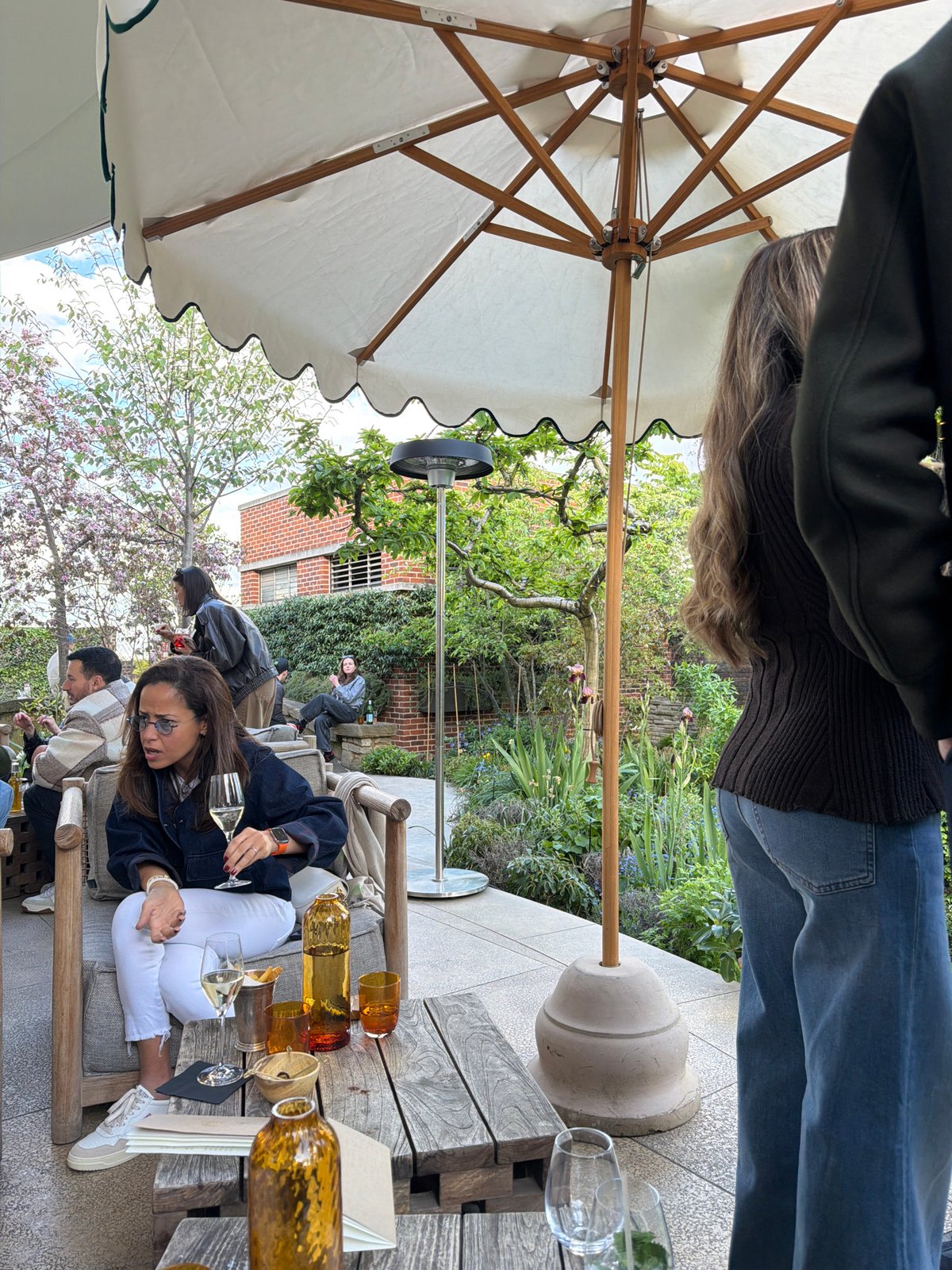 Outdoor dining scene unfolds in London with wine service