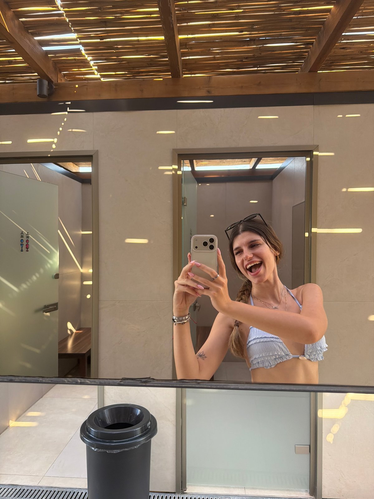 Woman documents beach day selfies at Greek resort