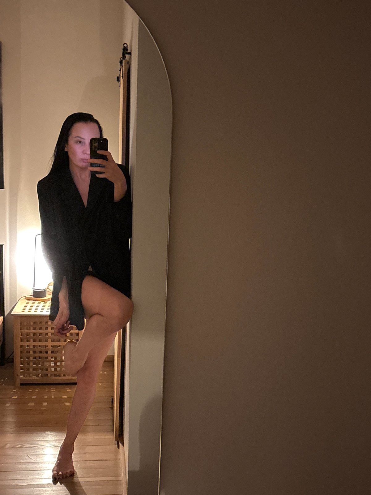 Woman rests with small dog in Chaikovsky home