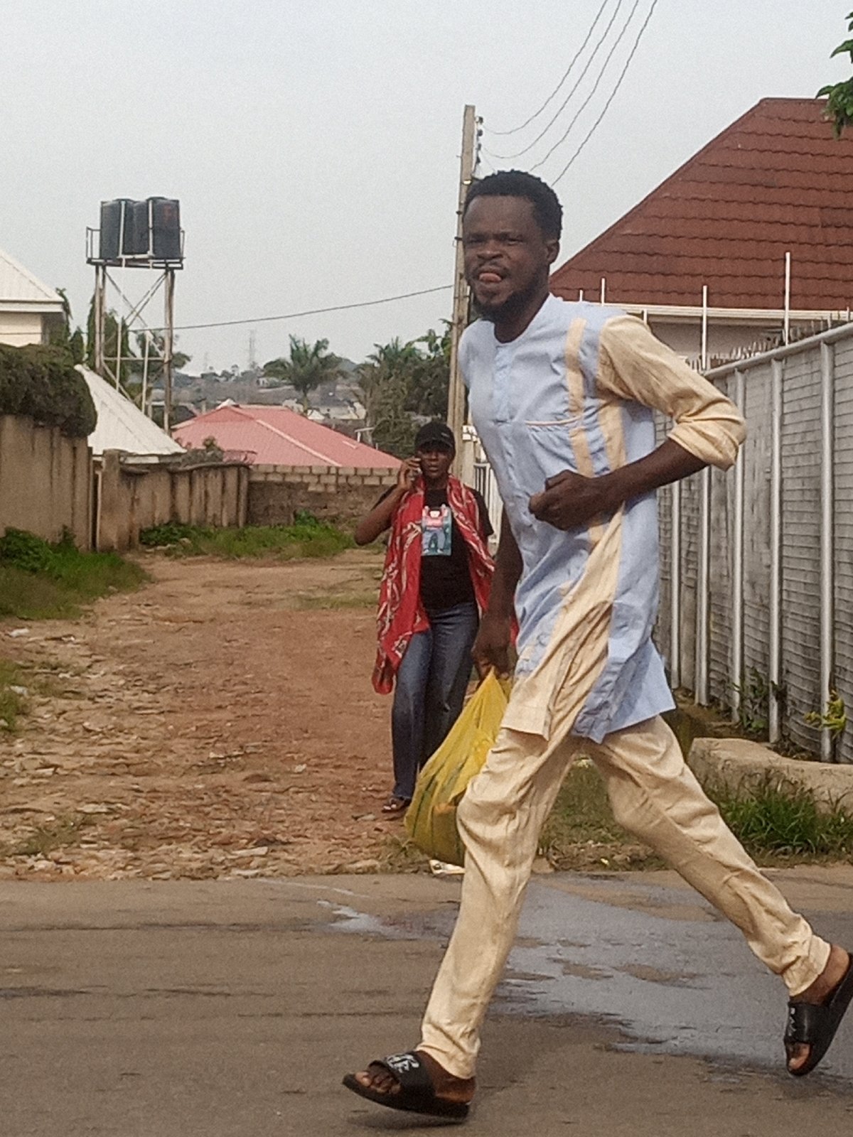 Everyday street life along dusty roads in a developing urban area