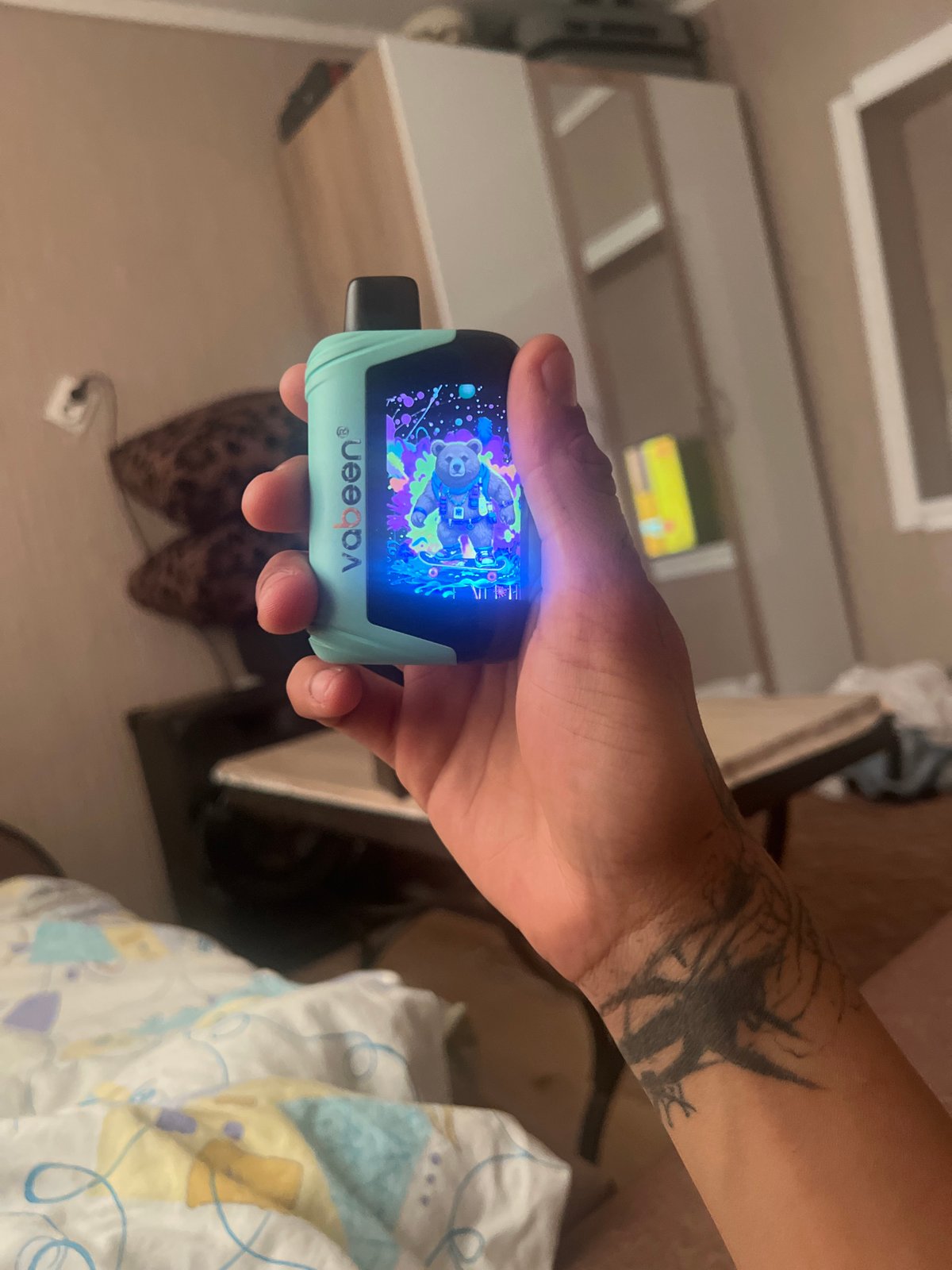 Person with tattoo uses electronic device in Sofia