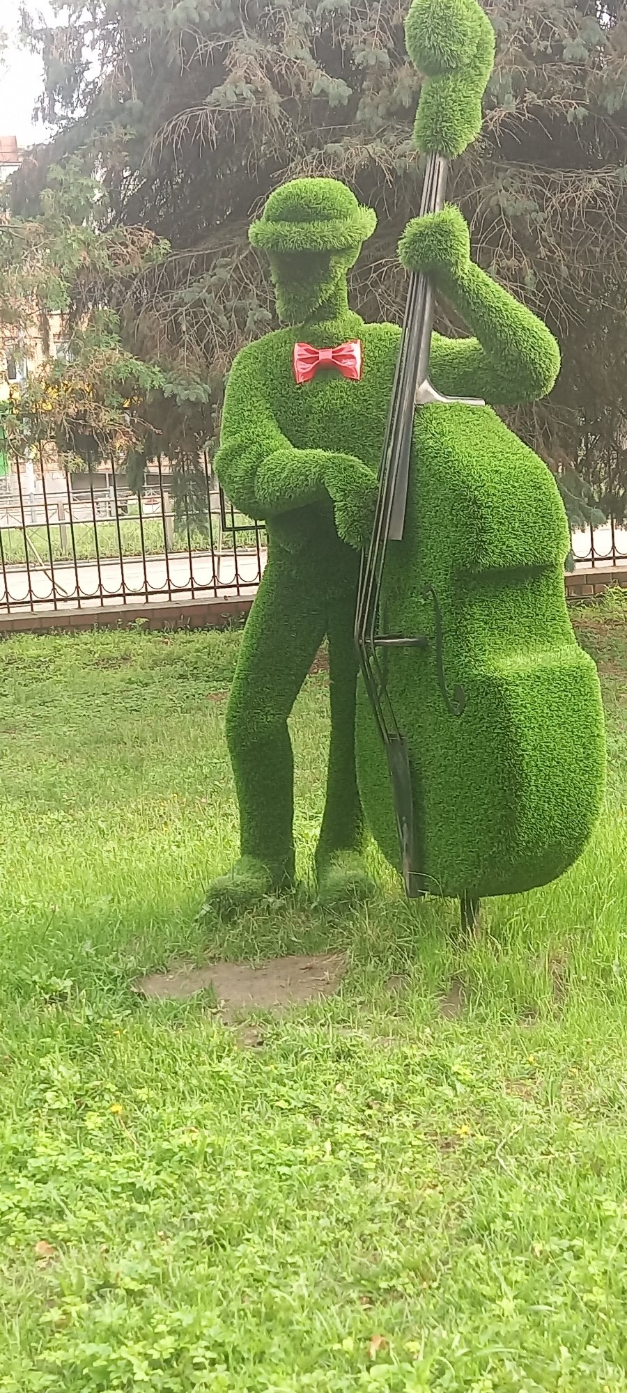 Topiary garden features musician and peacock shrub sculptures
