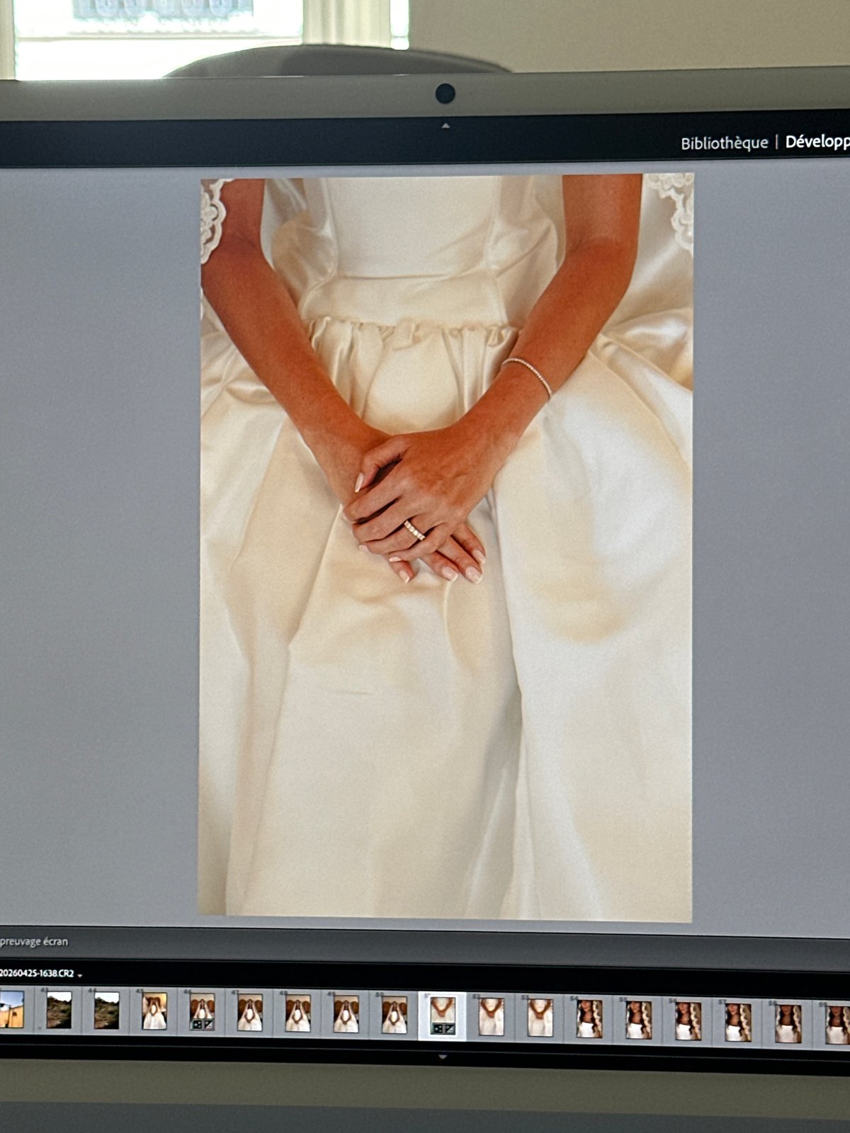 Bride's wedding ring photographed on dress in Paris