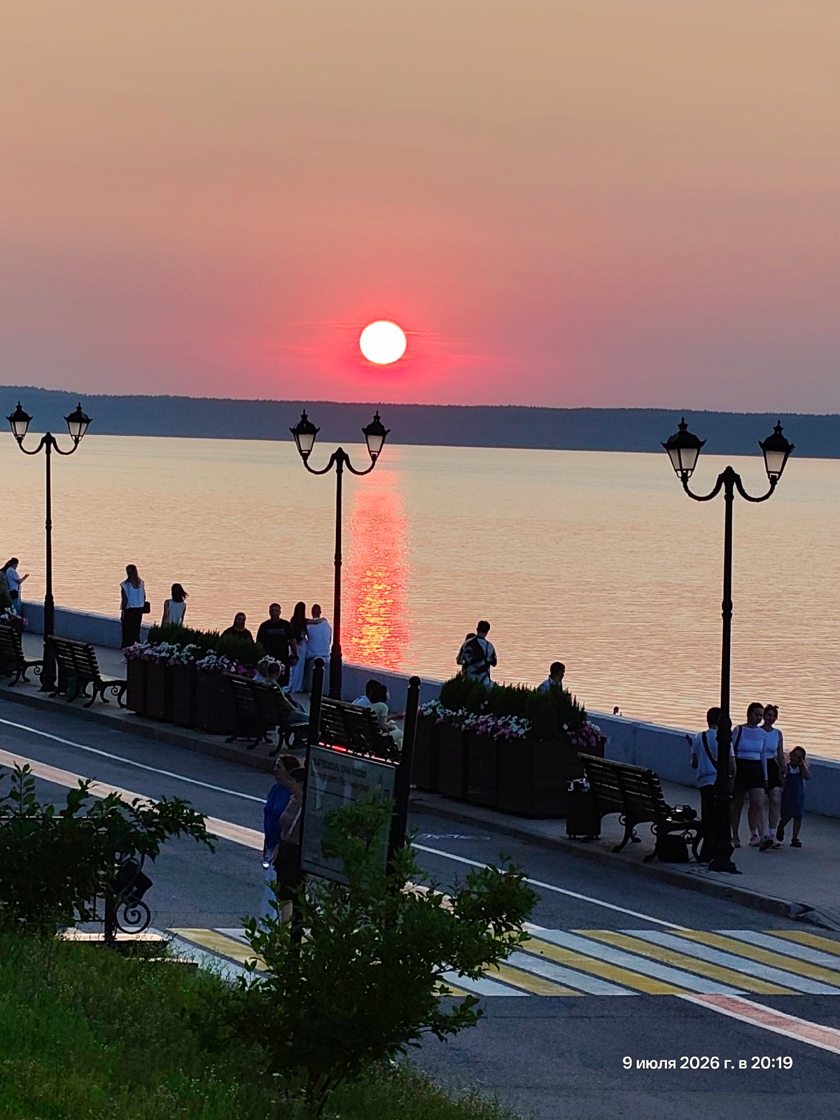 Sunset on the water as a passenger ship passes by