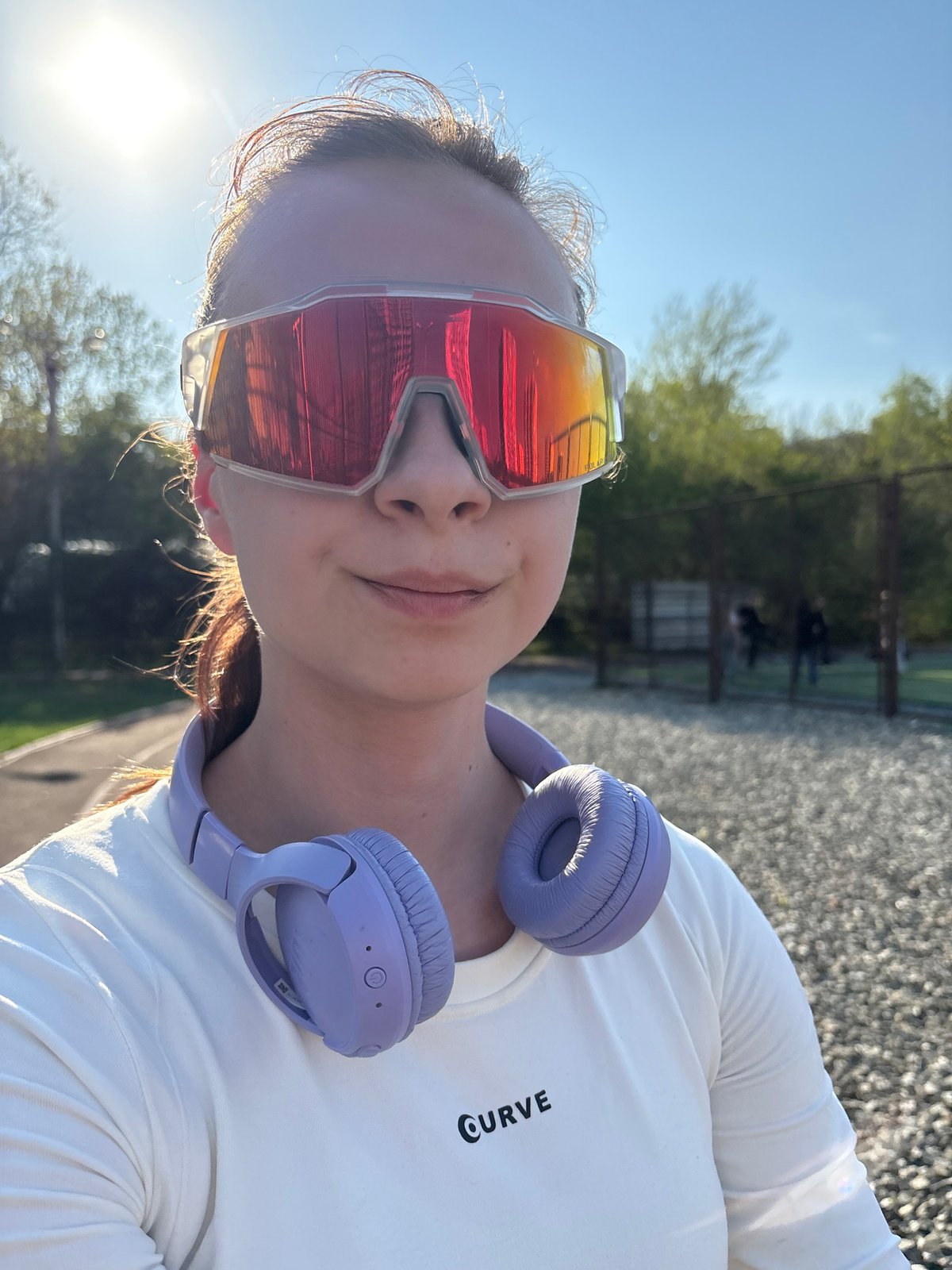 Woman photographs herself at athletic track in Perm, Russia