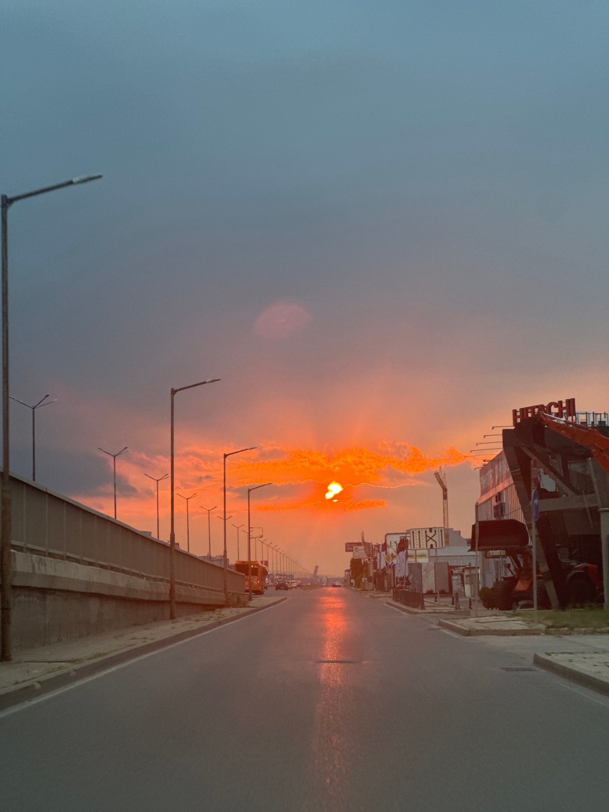Sofia street glows under a dramatic summer sunset sky