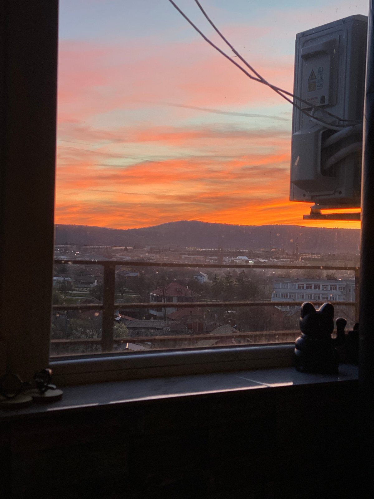 Sunset viewed over Targovishte cityscape from window