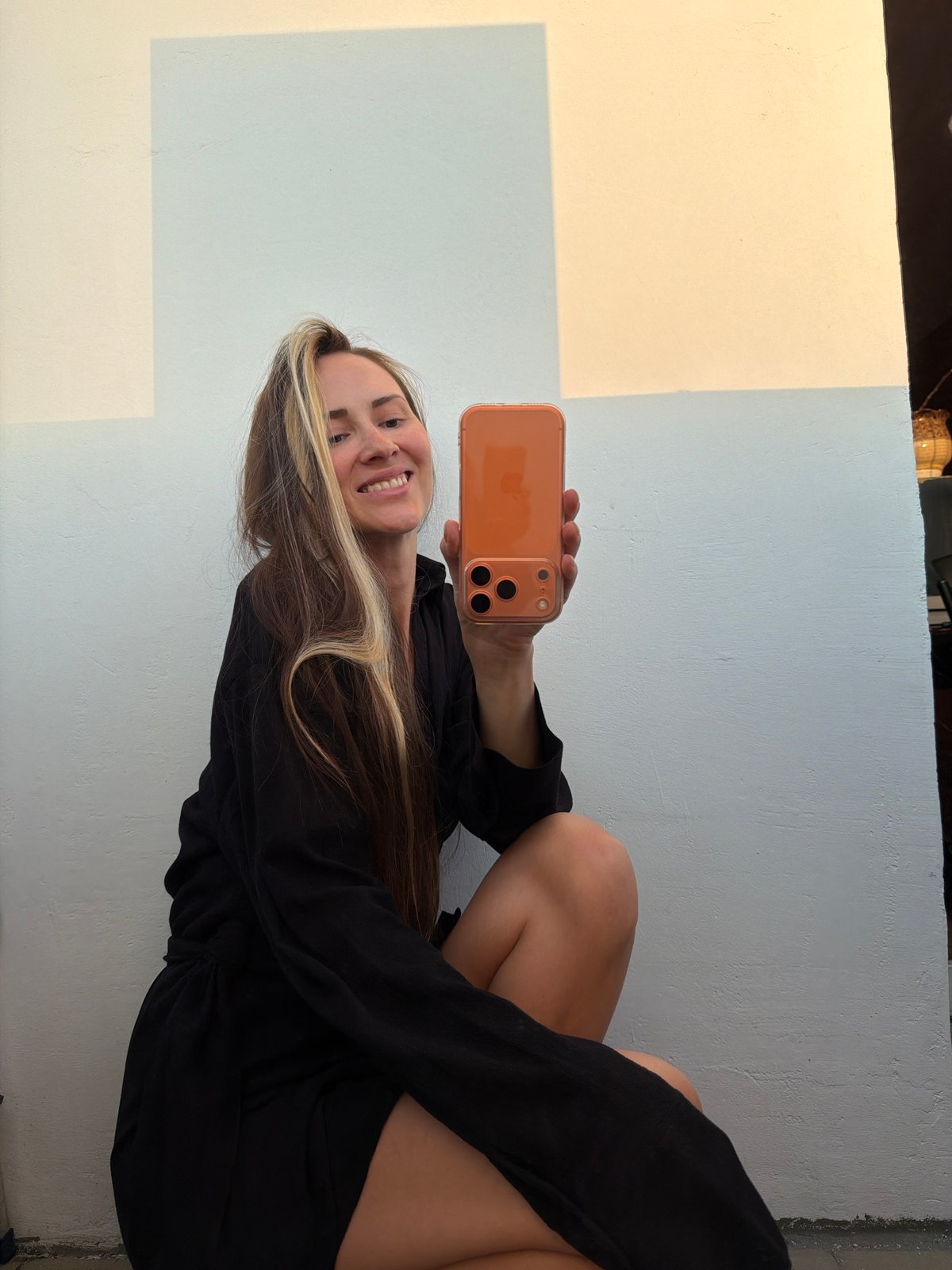 Woman takes selfies with orange phone in Khimki
