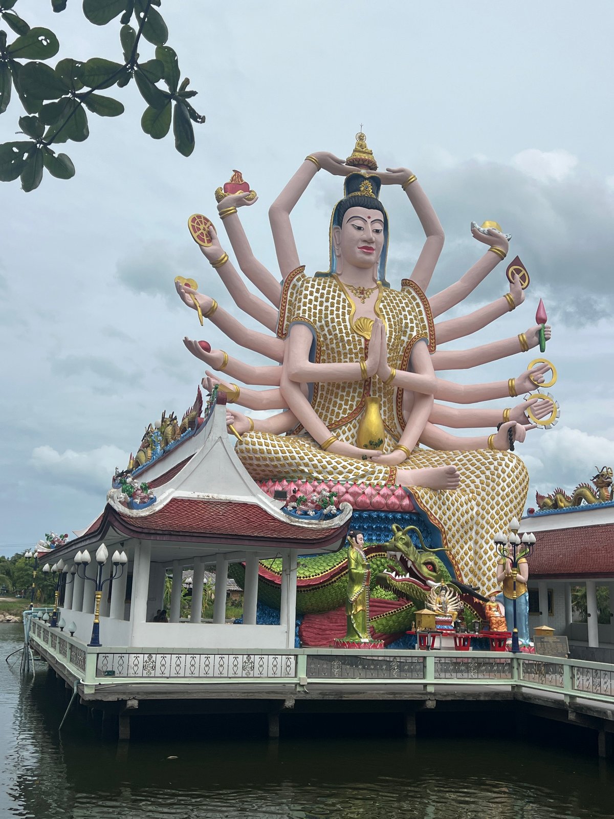 Ornate Guan Yin statue on colorful platform, Ko Samui