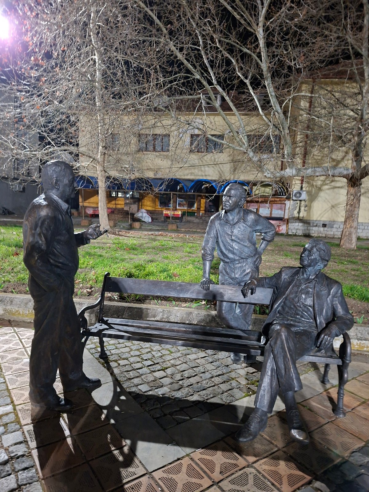 Visitors pose with bronze statues in Levski park