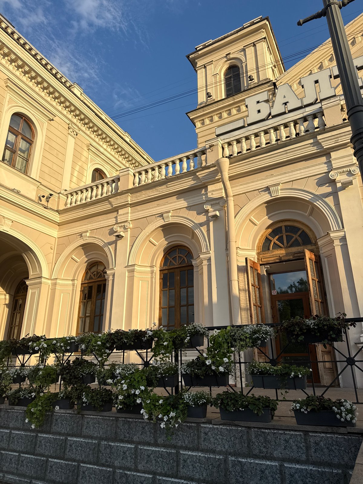 Woman explores classical architecture district, visits cafe during afternoon walkabout