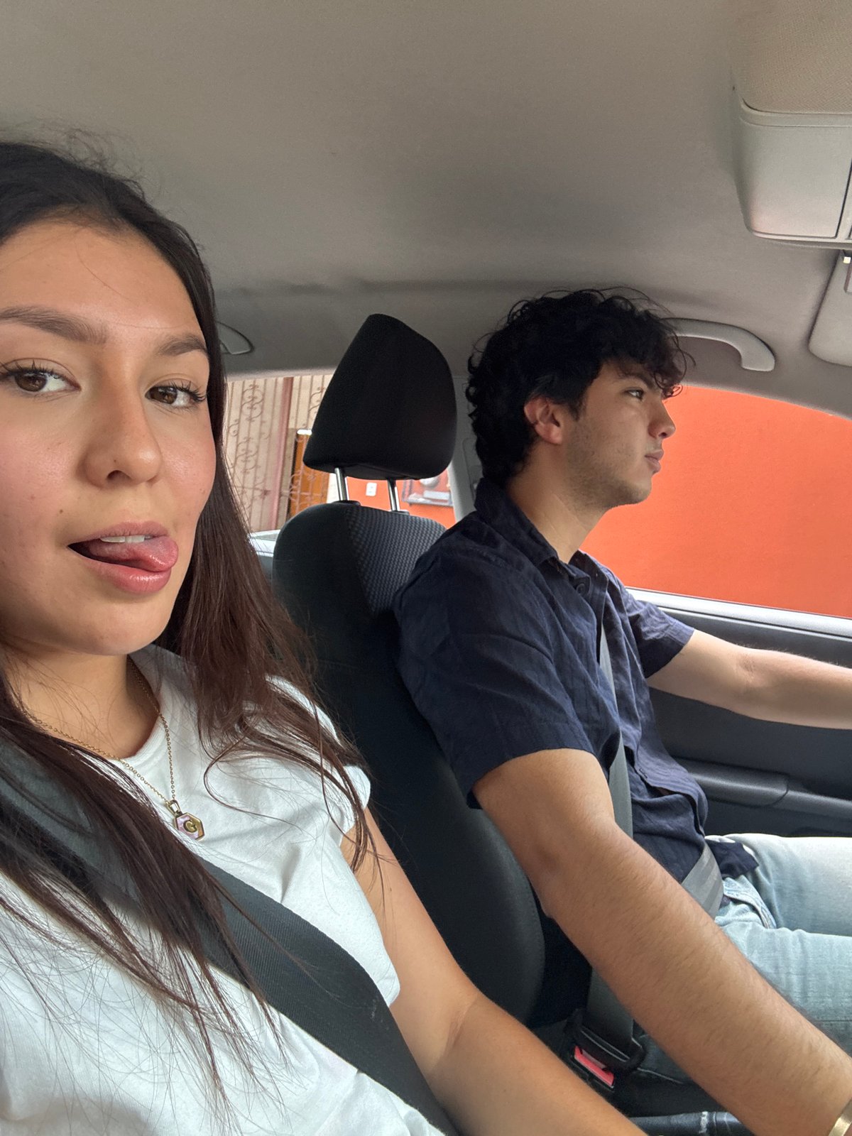 Two passengers travel by car in Oaxaca City