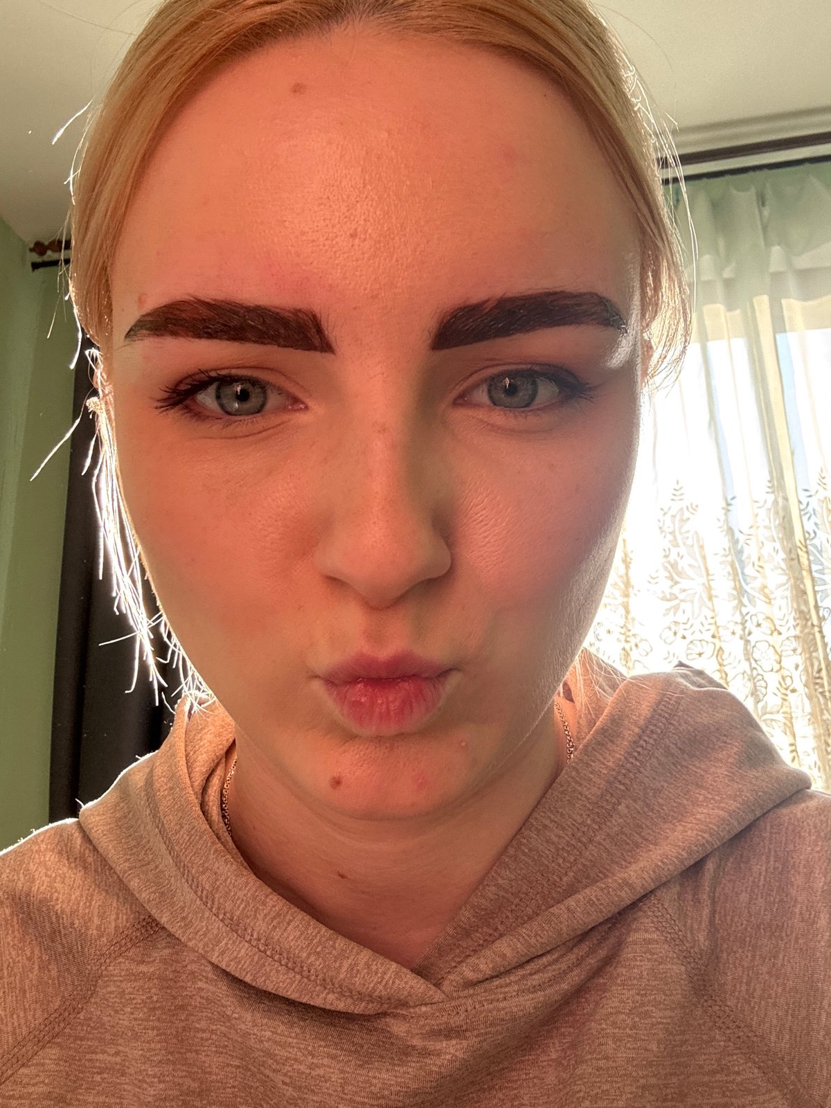 Woman takes selfies with varying expressions in Russia