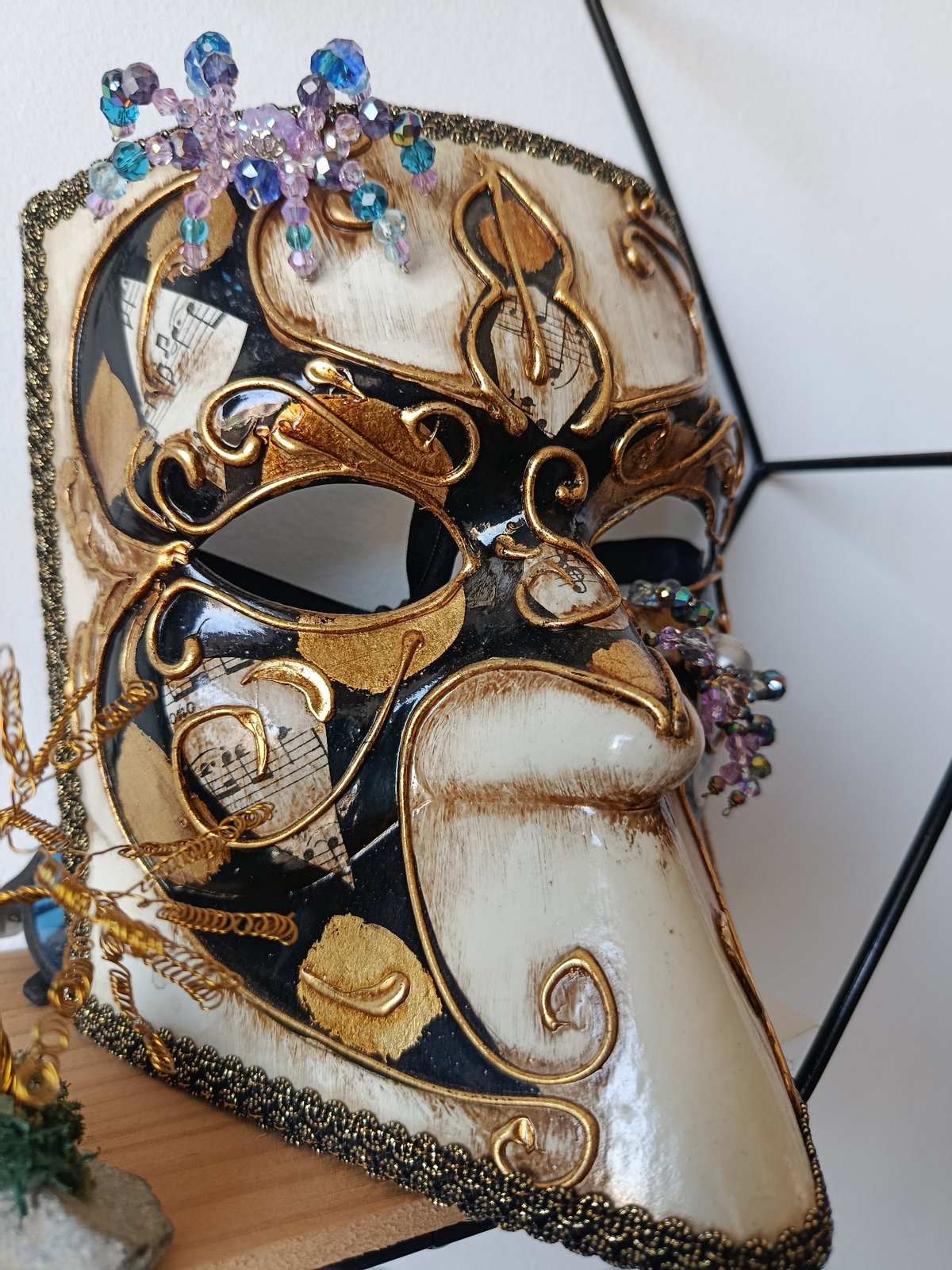 Close-up details: a Venetian mask, bicycle wheel, and stop sign.