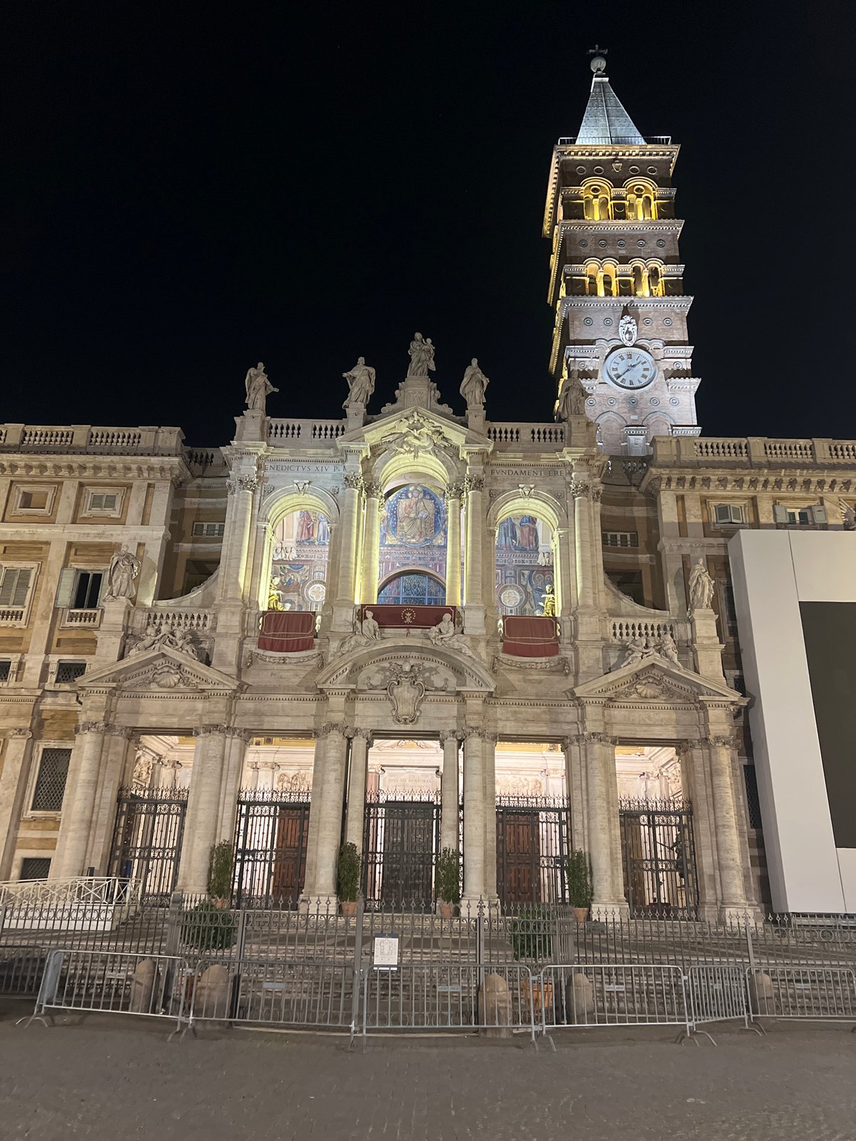 Historic Rome basilica and bell tower illuminated at night