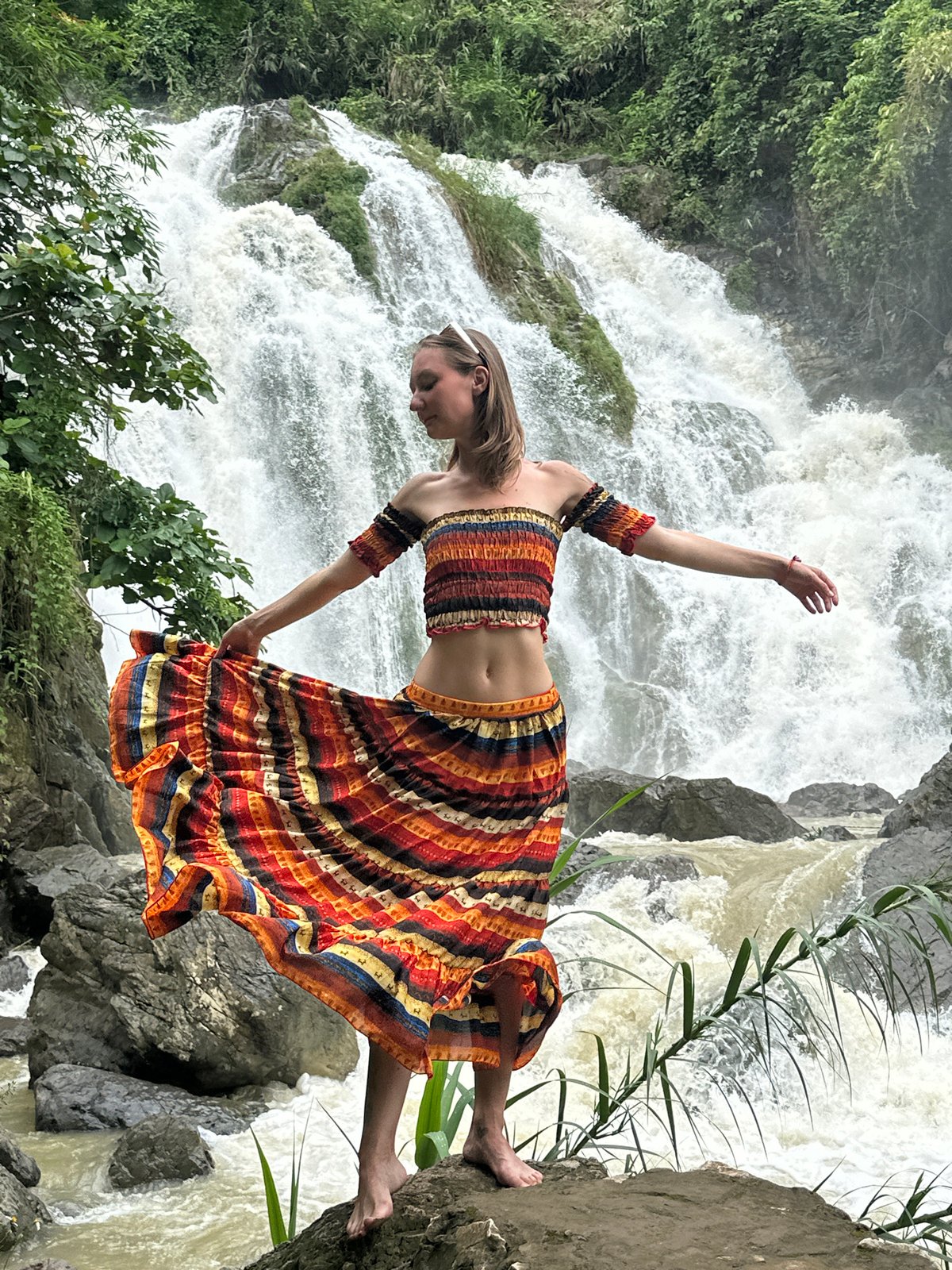 Tourists pose and photograph at Bản Phúc waterfall, Vietnam
