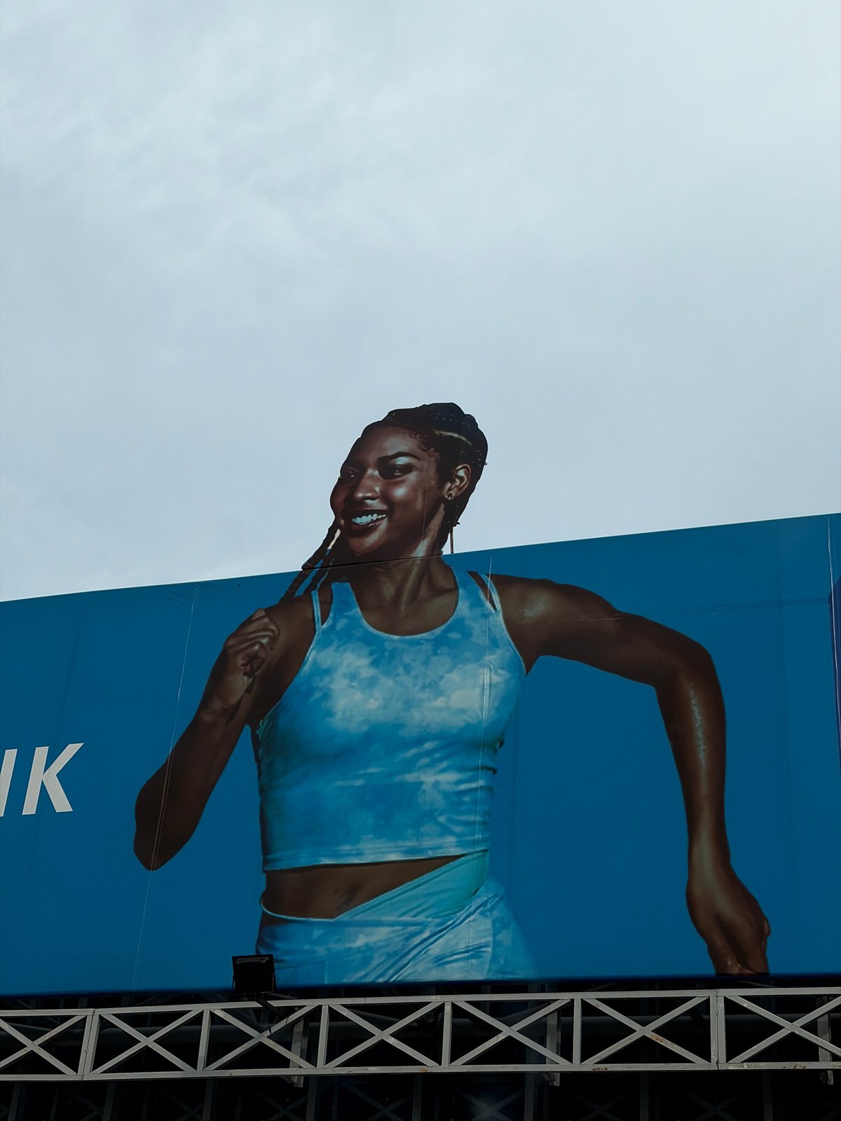 Athletic advertisement and modern building observed in Lagos area