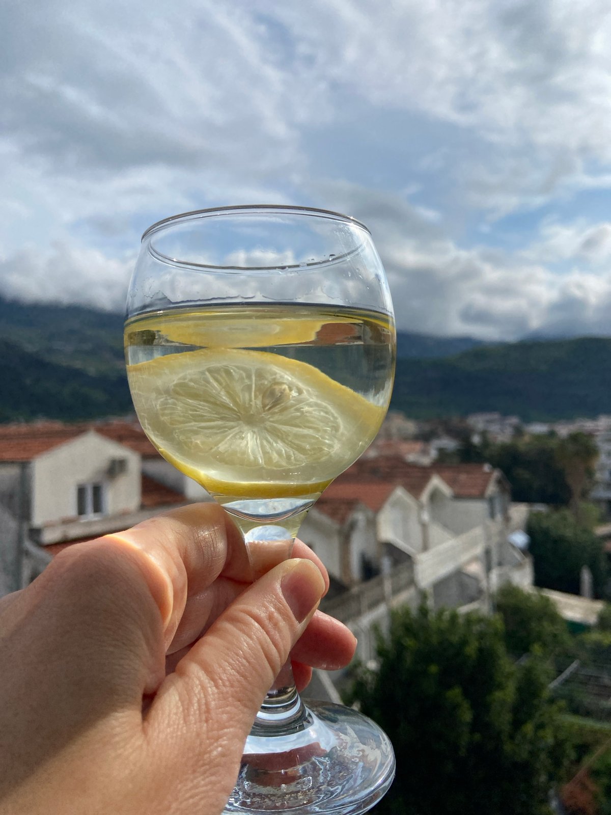 Morning refreshment captured overlooking Budva's mountain landscape