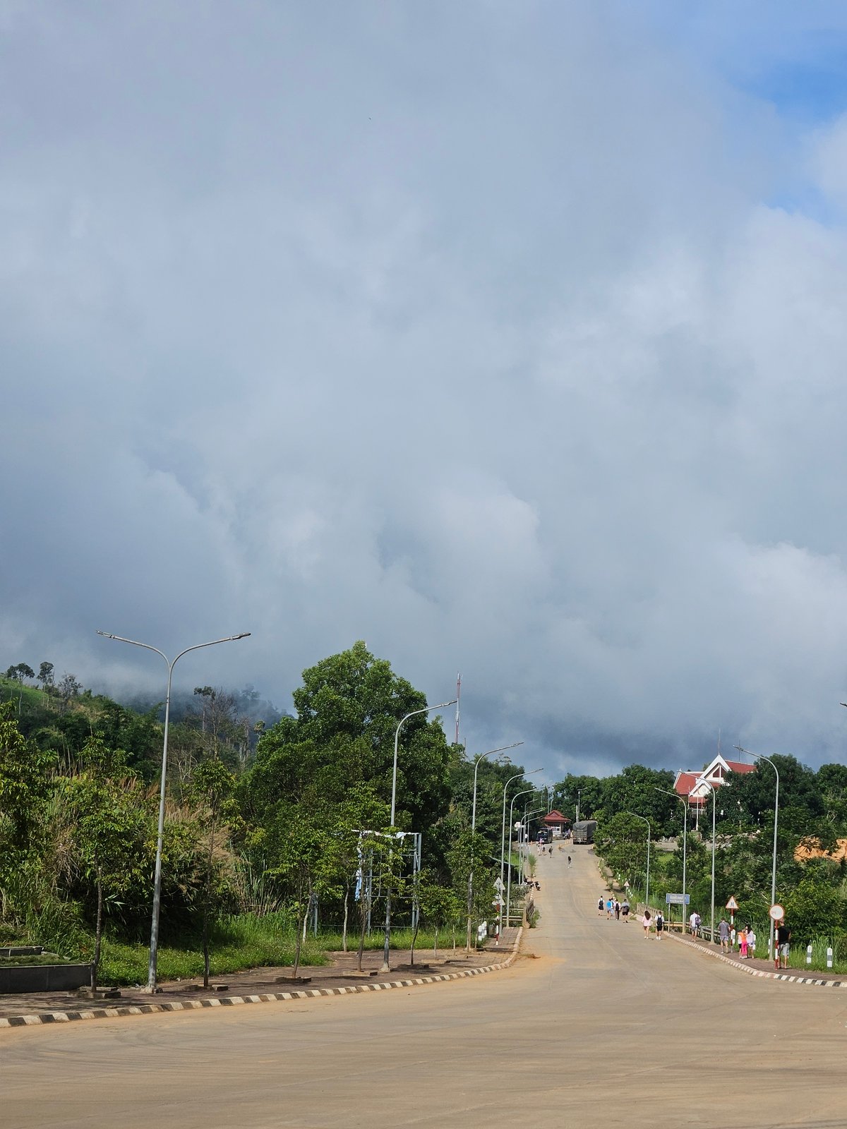 Green hills, red cliffs, and a winding road on the Vietnam-Laos border