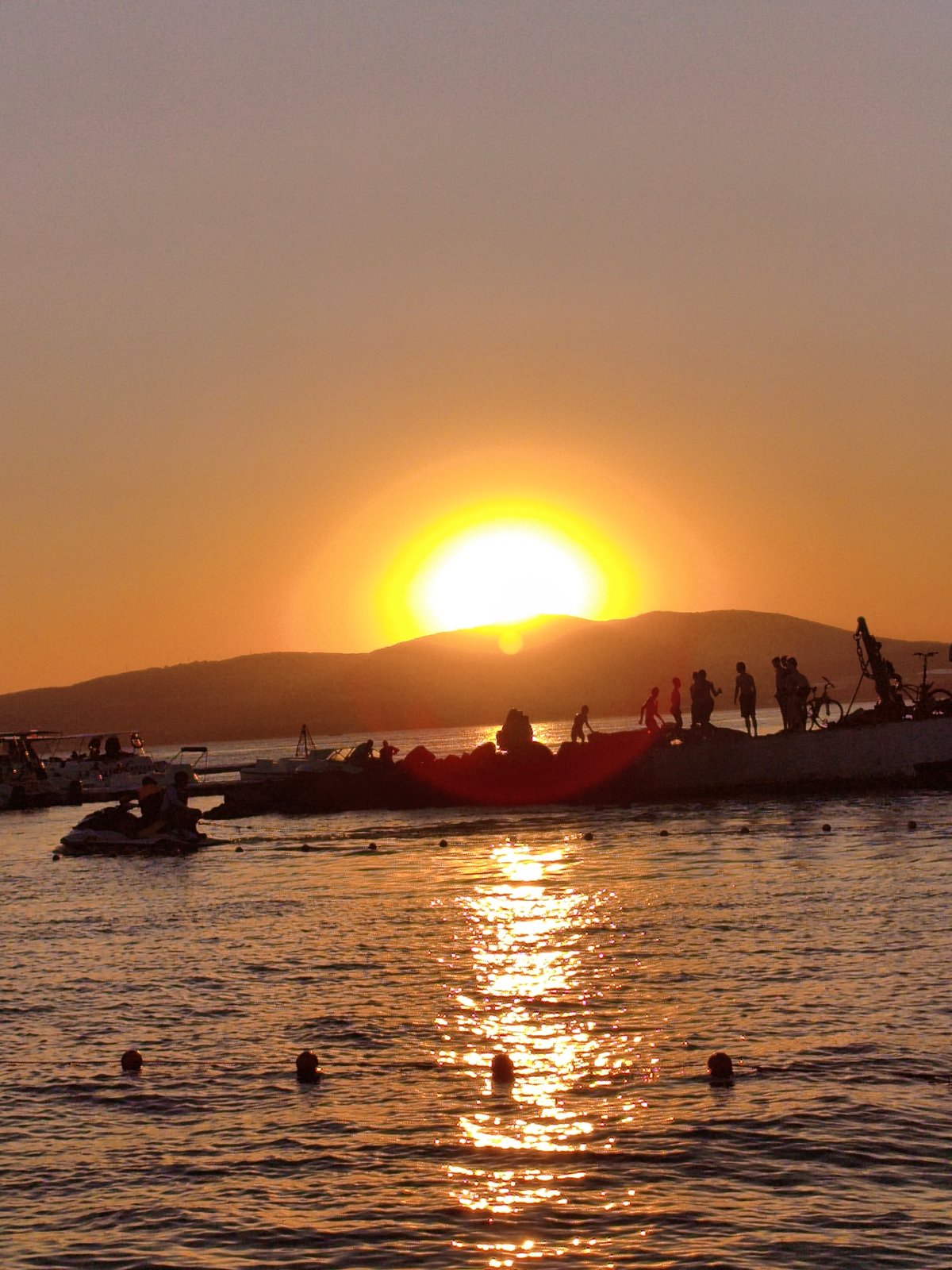 Gelendzhik beachfront at golden hour — sculptures, sea, and sunset