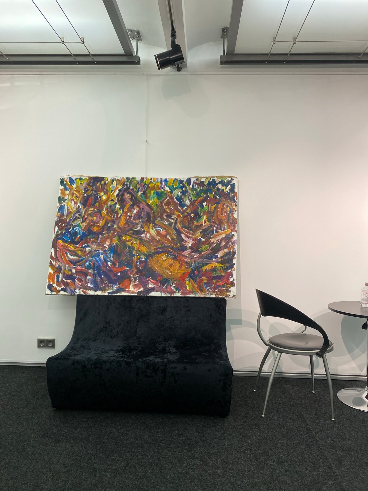 Art exhibit with abstract painting, velvet furniture documented in Moscow
