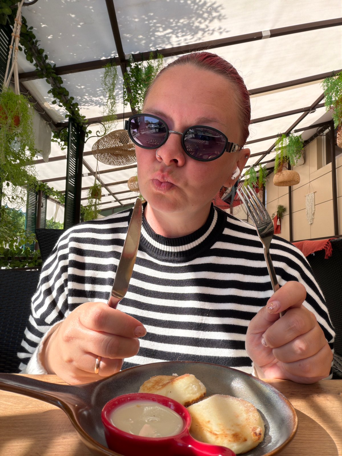 Woman dines outdoors at early morning restaurant in Chaikovsky