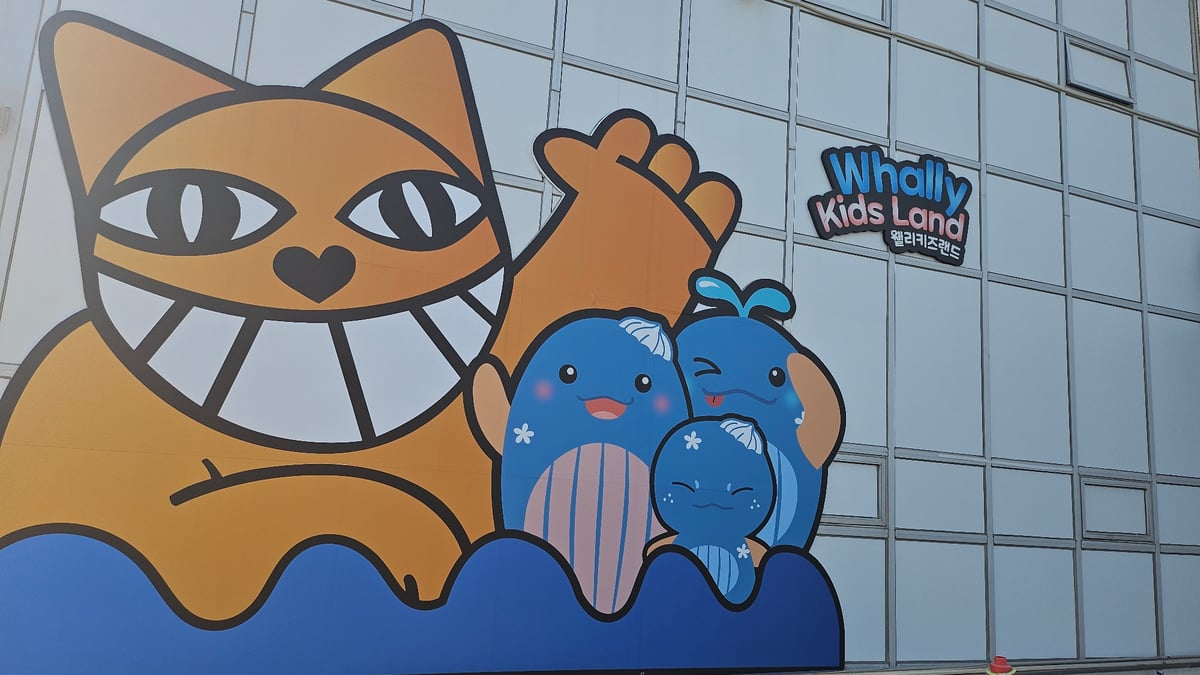 Tourist documents whale-themed attractions at Ulsan cultural village